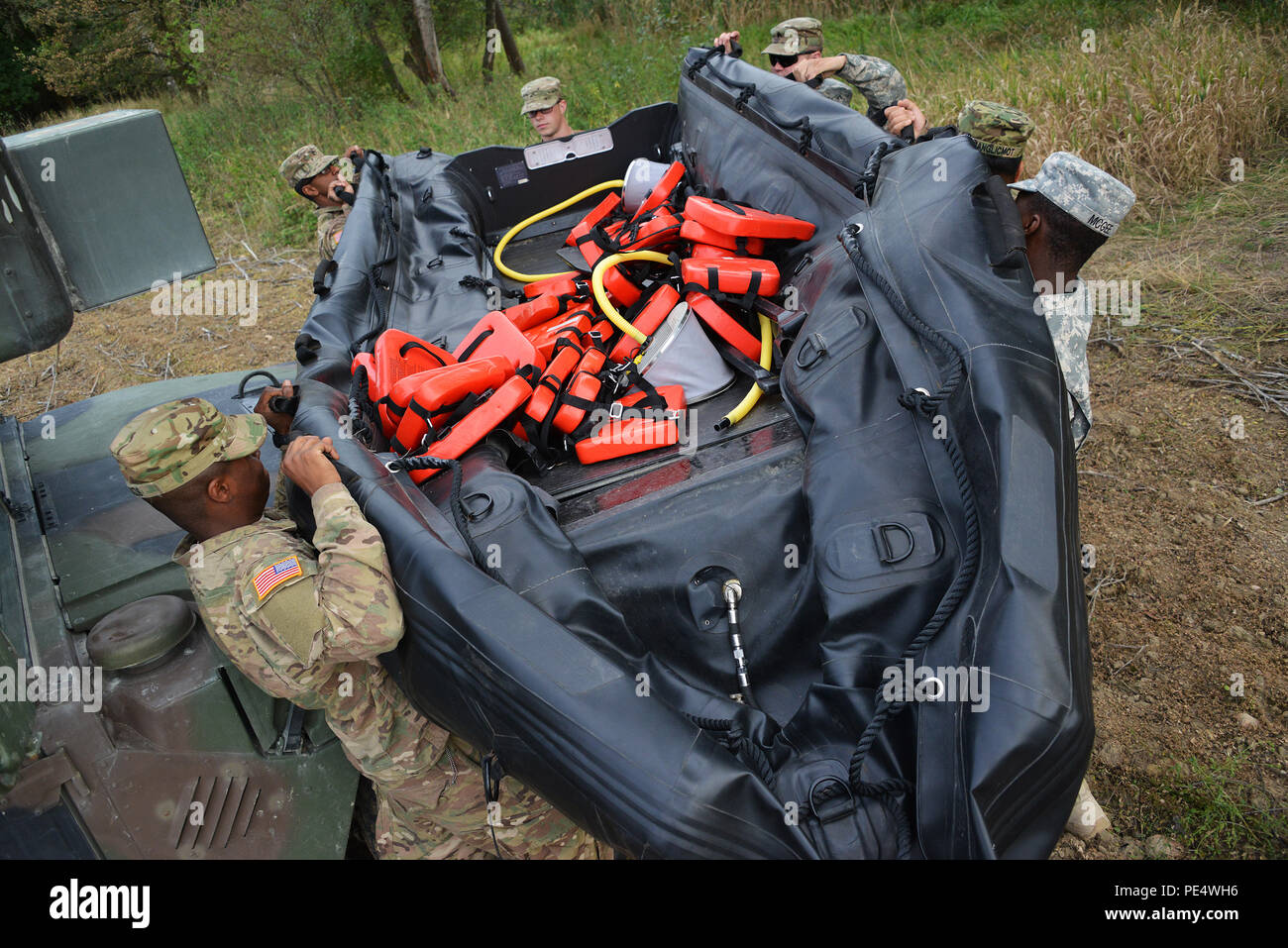 U.S. Army paratroopers, assigned to 1st Squadron, 91st Cavalry Regiment, 173rd Airborne Brigade, prepare a Zodiac inflatable boat as part of Exercise Sky Soldier II at Bechyne Training Area, Czech Republic, Sept. 22, 2015. Sky Soldier is a series of bilateral exercises between the 173rd Airborne Brigade and the Czech army’s 4th Rapid Reaction Brigades designed to increase interoperability and strengthen partnerships between NATO airborne forces. (U.S. Army photo by Visual Information Specialist Gertrud Zach/released) Stock Photo