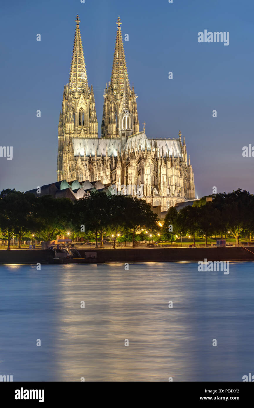 The famous illuminated Koelner Dom with the river Rhine at night Stock Photo
