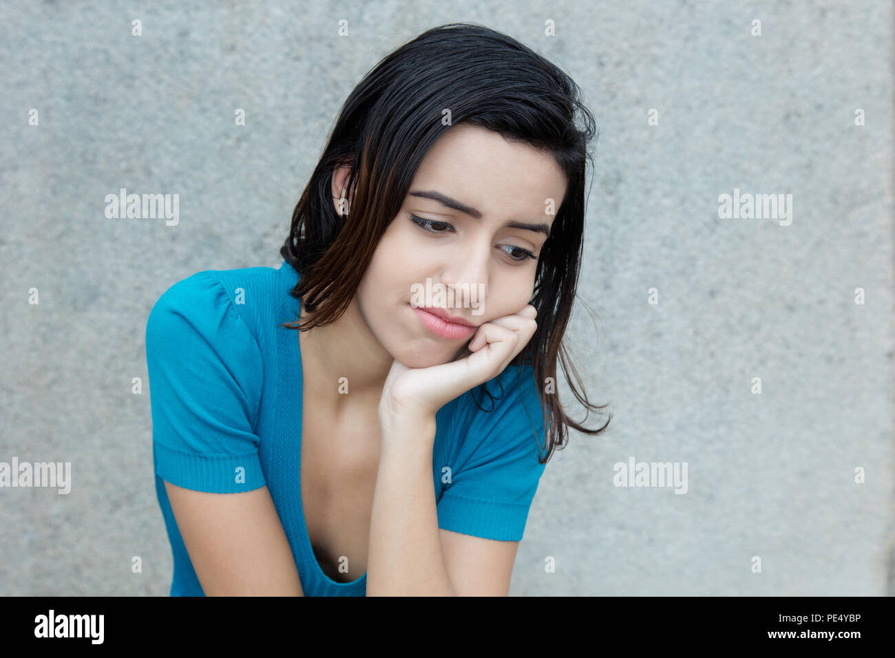 Bullied latin american young adult woman outdoors with copy space Stock Photo