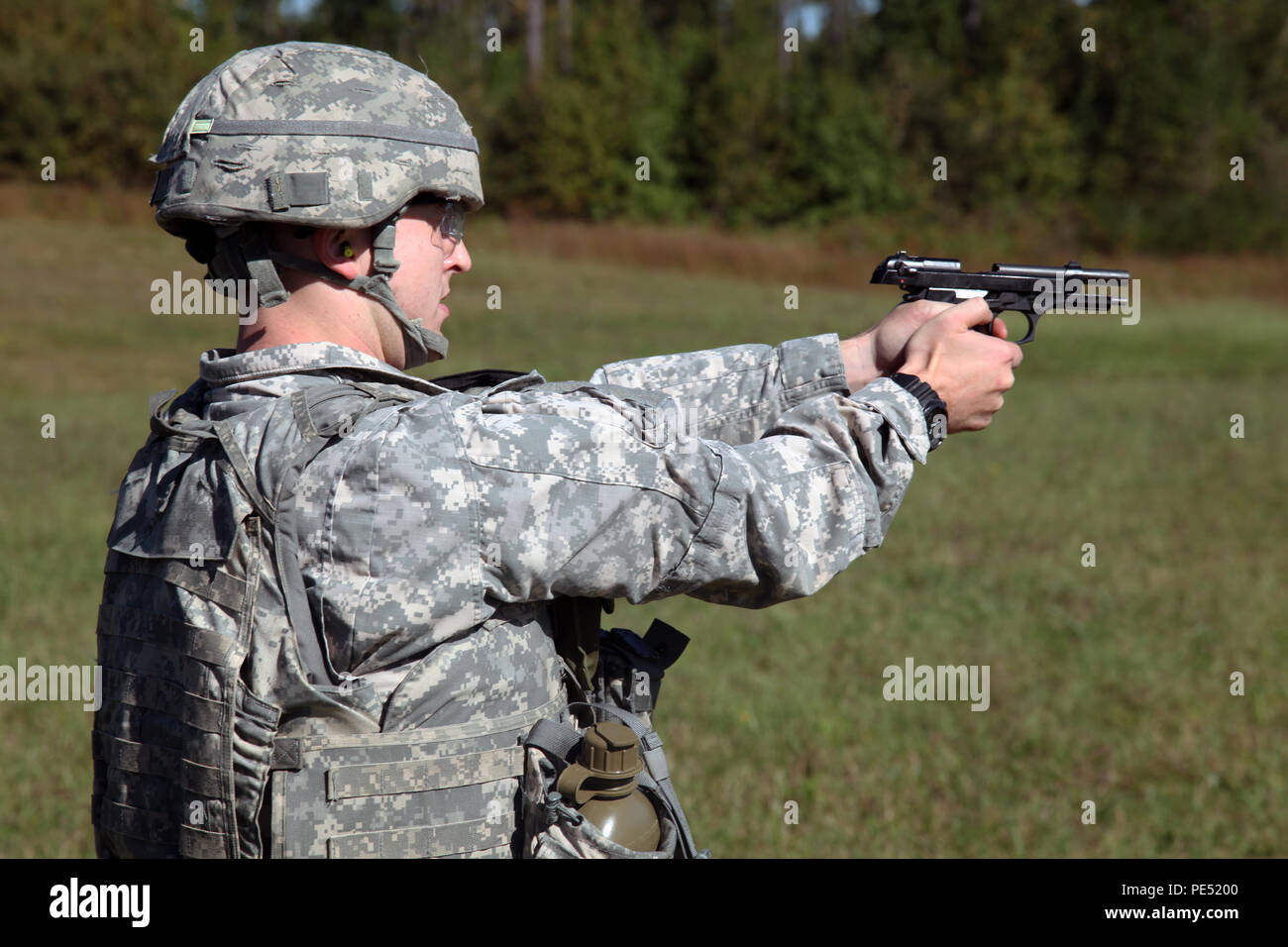 U.S. Army Spc. Adam Walton, assigned to AMC Band, U.S. Army Material Command, qualifies with his M9 Beretta during the U.S. Army’s Best Warrior Competition at Fort A.P. Hill, Va., Oct. 6, 2015. The competition is a grueling, weeklong event that tests the skills, knowledge and professionalism of 26 warriors representing 13 commands. (U.S. Army Photo by Pfc. Christopher Brecht/Released) #BestWarrior Stock Photo