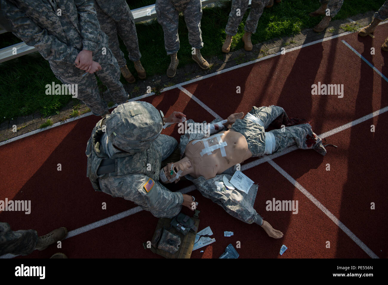 U.S. Army Staff Sgt. Erik Poveda, with Allied Forces North Battalion, U.S. Army NATO Brigade, explains how to apply an asherman chest seal using a training mannequin to Soldiers with 128th Signal Company and Headquarters and Headquarters Detachment, 39th Signal Battalion, during the Combat Life Saver part of Battalion Commander's Prime Time Training, on Chièvres Air Base, Chièvres, Belgium, Sept. 21, 2015. (U.S. Army photo by Visual Information Specialist Pierre-Etienne Courtejoie/Released) Stock Photo