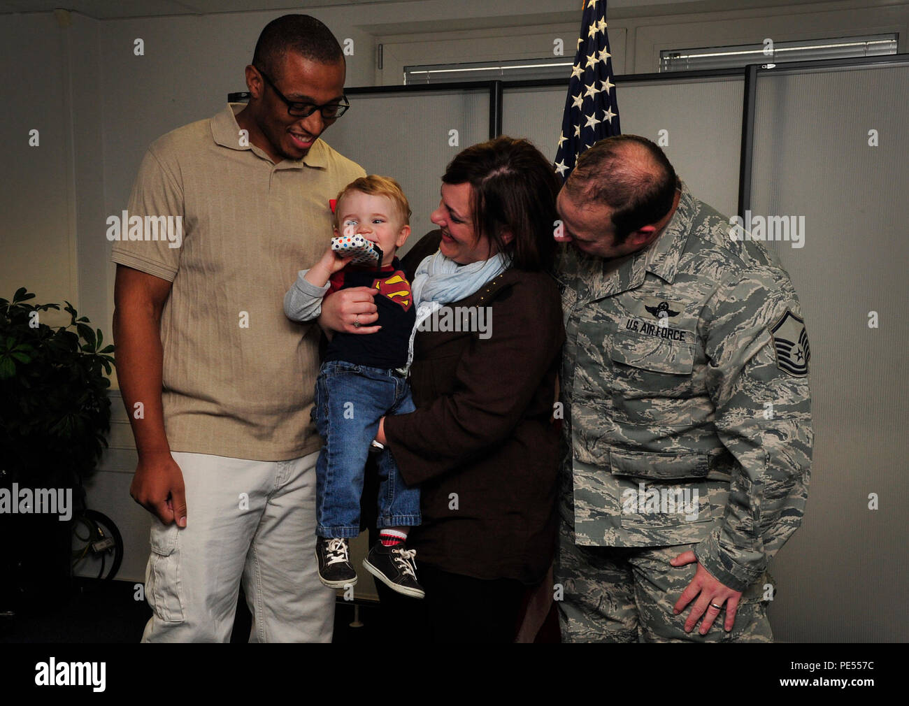 Sean Tatum, 86th Force Support Squadron caregiver, stands with the Dalmo family for photos during a Red Cross Lifesaving Award ceremony Oct. 8, 2015, at Ramstein Air Base, Germany. Tatum utilized his Red Cross health and safety skills to dislodge food from Jackson Dalmo’s throat July 1, 2015. (U.S. Air Force photo/Airman 1st Class Larissa Greatwood) Stock Photo