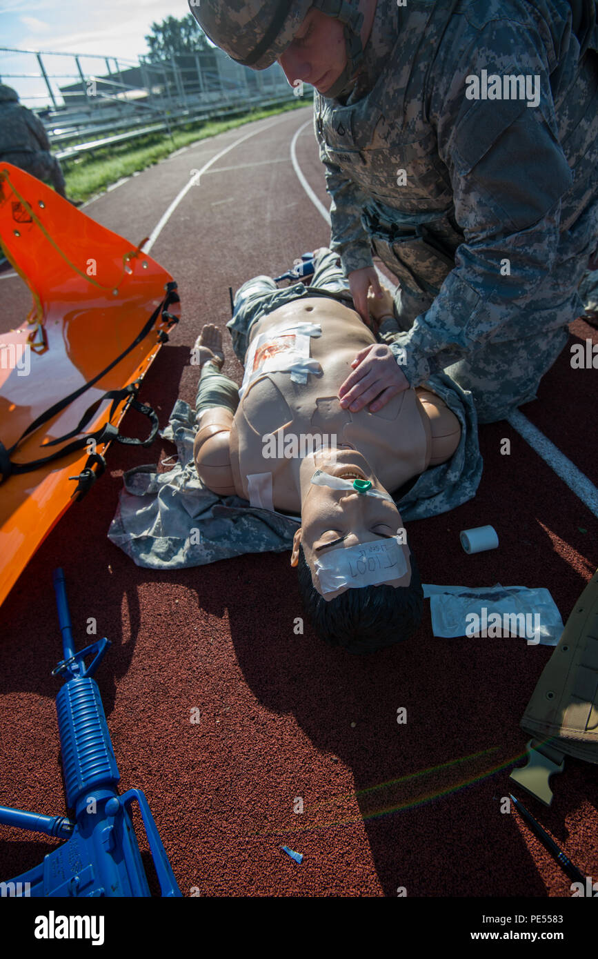 U.S. Army Pfc. Zachary Rehm, assigned to Headquarters and Headquarters Detachment (HHD), 39th Signal Battalion, evaluates the wounds on a training mannequin, prior to place it on flexible stretcher, during Combat Life Saver exercises for the Battalion Commander's Prime Time Training, on Chièvres Air Base, Chièvres, Belgium, Sept. 21, 2015. (U.S. Army photo by Visual Information Specialist Pierre-Etienne Courtejoie/Released) Stock Photo