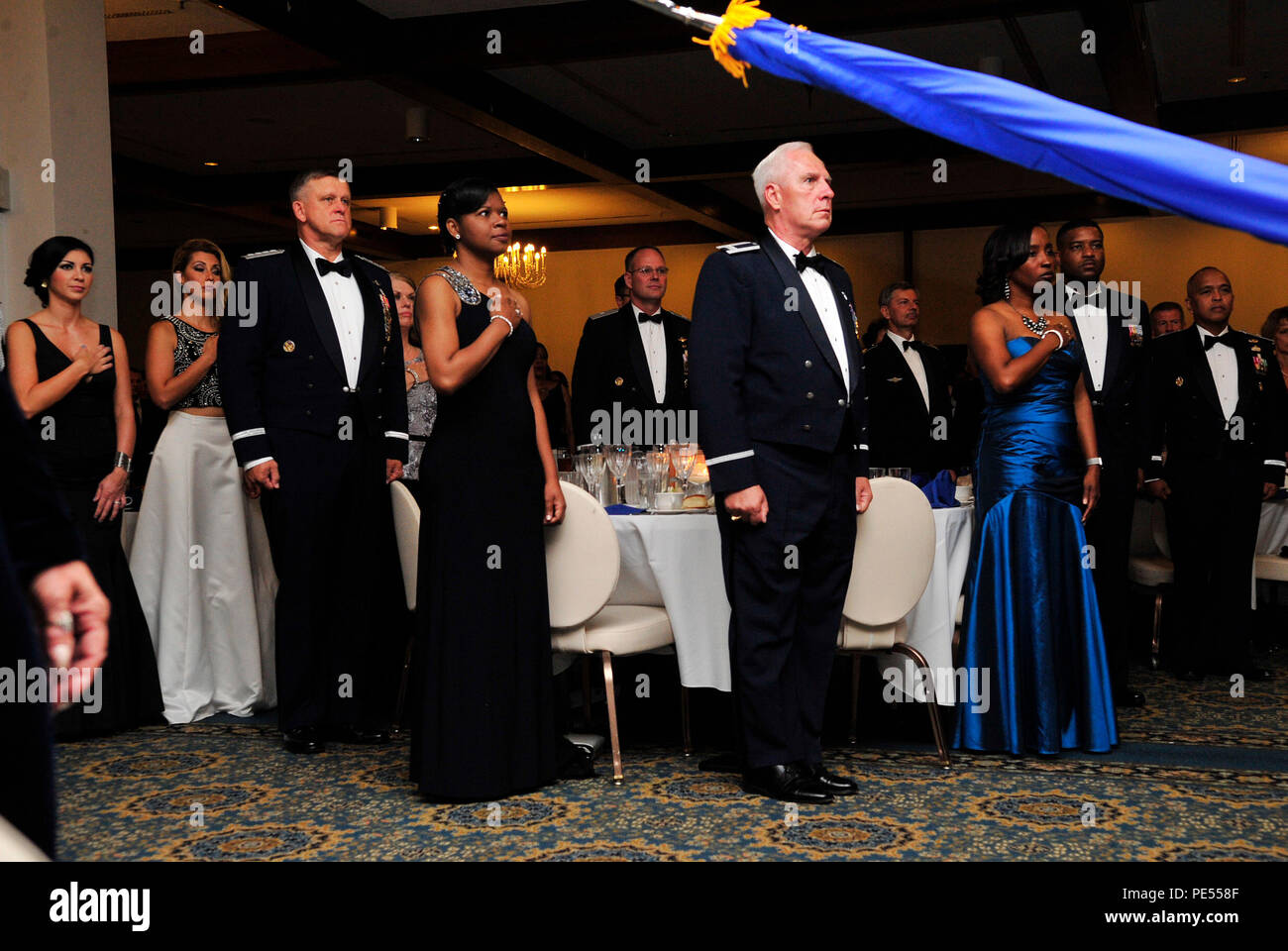 Air Force leaders and guests stand for the singing of both the German and American national anthems during the Air Force Ball, Sept. 12, 2015, at Ramstein Air Base, Germany. The Air Force officially celebrated its 68th birthday as an independent branch Sept. 18, 2015. (U.S. Air Force photo/Airman 1st Class Larissa Greatwood) Stock Photo