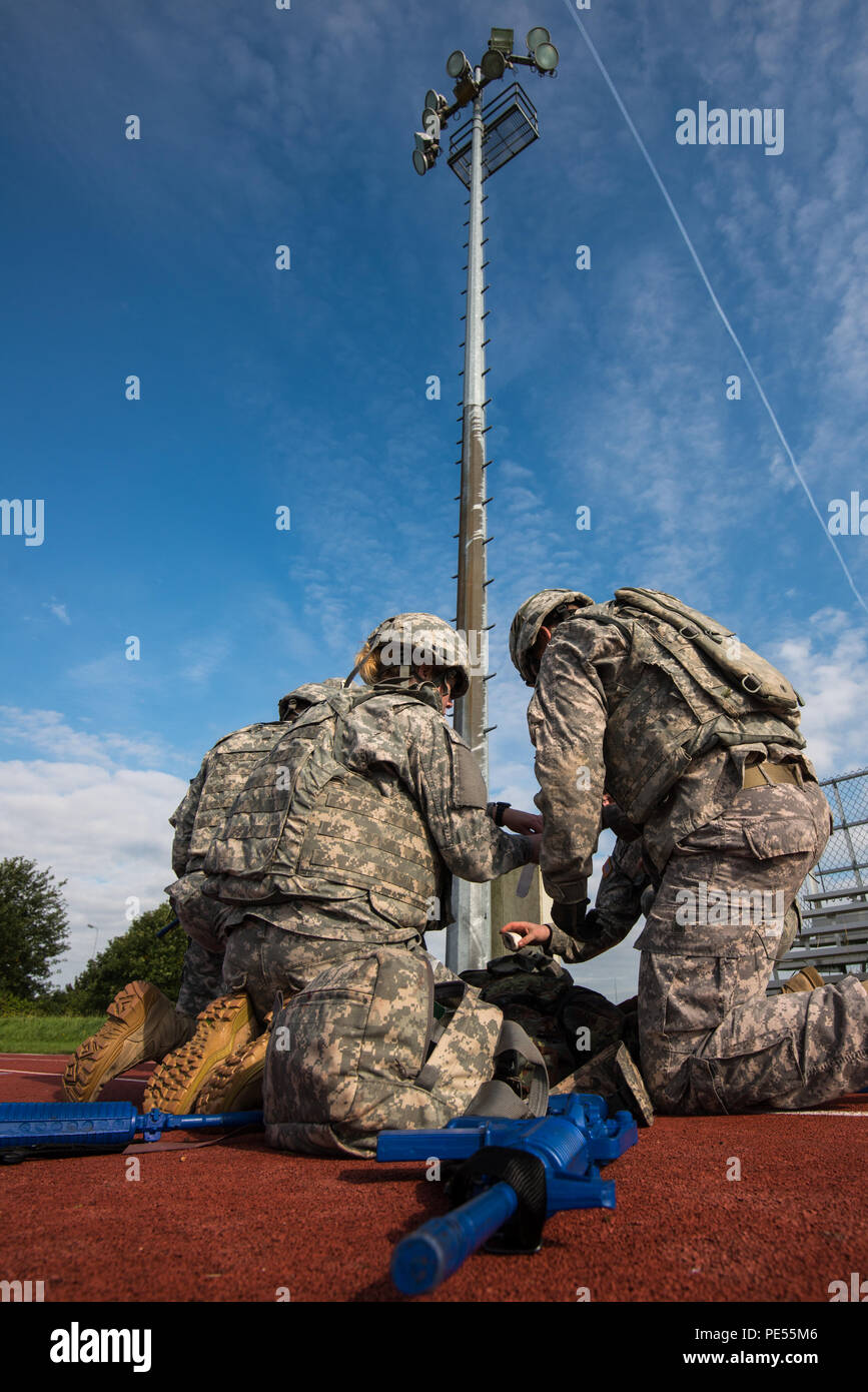 U.S. Soldiers with 128th Signal Company and Headquarters and Headquarters Detachment, 39th Signal Battalion, treat a casualty during Combat Life Saver exercises for the Battalion Commander's Prime Time Training, on Chièvres Air Base, Chièvres, Belgium, Sept. 21, 2015. (U.S. Army photo by Visual Information Specialist Pierre-Etienne Courtejoie/Released) Stock Photo