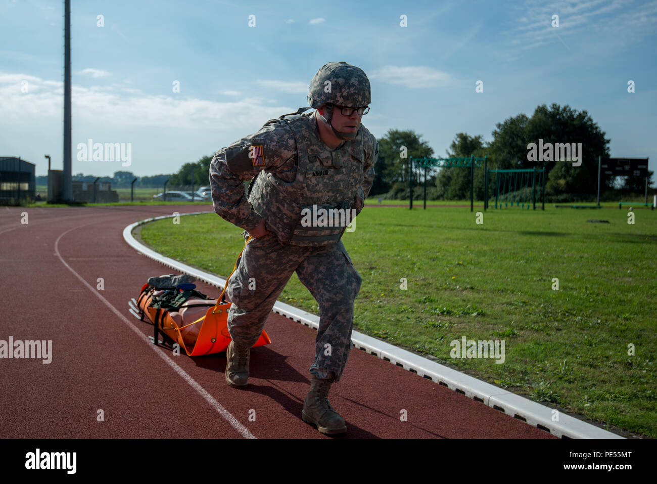 U.S. Army 2nd Lt. Mark Mihalik, with 128th Signal Company, 39th Signal Battalion, evacuates a simulated casualty using a flexible stretcher, during the Battalion Commander's Prime Time Training, on Chièvres Air Base, Chièvres, Belgium, Sept. 21, 2015. (U.S. Army photo by Visual Information Specialist Pierre-Etienne Courtejoie/Released) Stock Photo