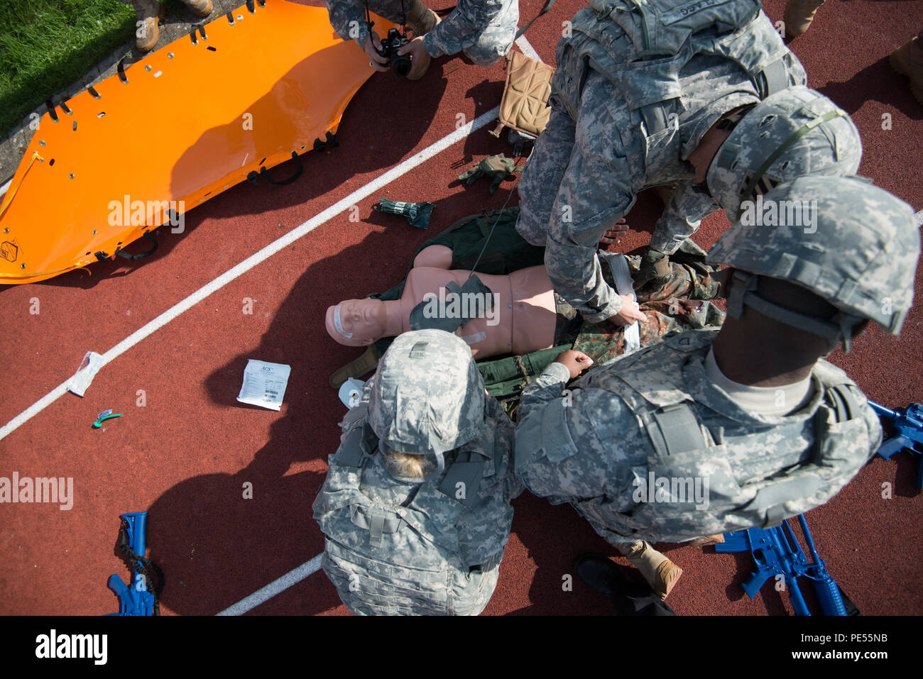 U.S. Soldiers with 128th Signal Company and Headquarters and Headquarters Detachment, 39th Signal Battalion, evaluate and treat wounds on a simulated casualty as they perform Combat Life Saver exercises during the Battalion Commander's Prime Time Training, on Chièvres Air Base, Chièvres, Belgium, Sept. 21, 2015. (U.S. Army photo by Visual Information Specialist Pierre-Etienne Courtejoie/Released) Stock Photo