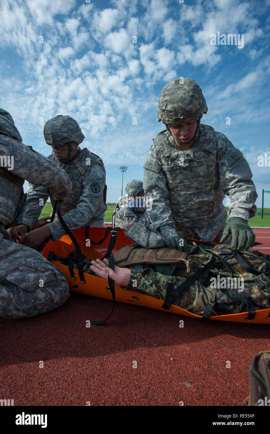 U.S. Army Sgt. Erik Fuentes, right, Headquarters and Headquarters Detachment, 39th Signal Battalion, secures a casualty on a flexible stretcher during Commander's Prime Time Training, on Chièvres Air Base, Chièvres, Belgium, Sept. 21, 2015. (U.S. Army photo by Visual Information Specialist Pierre-Etienne Courtejoie/Released) Stock Photo