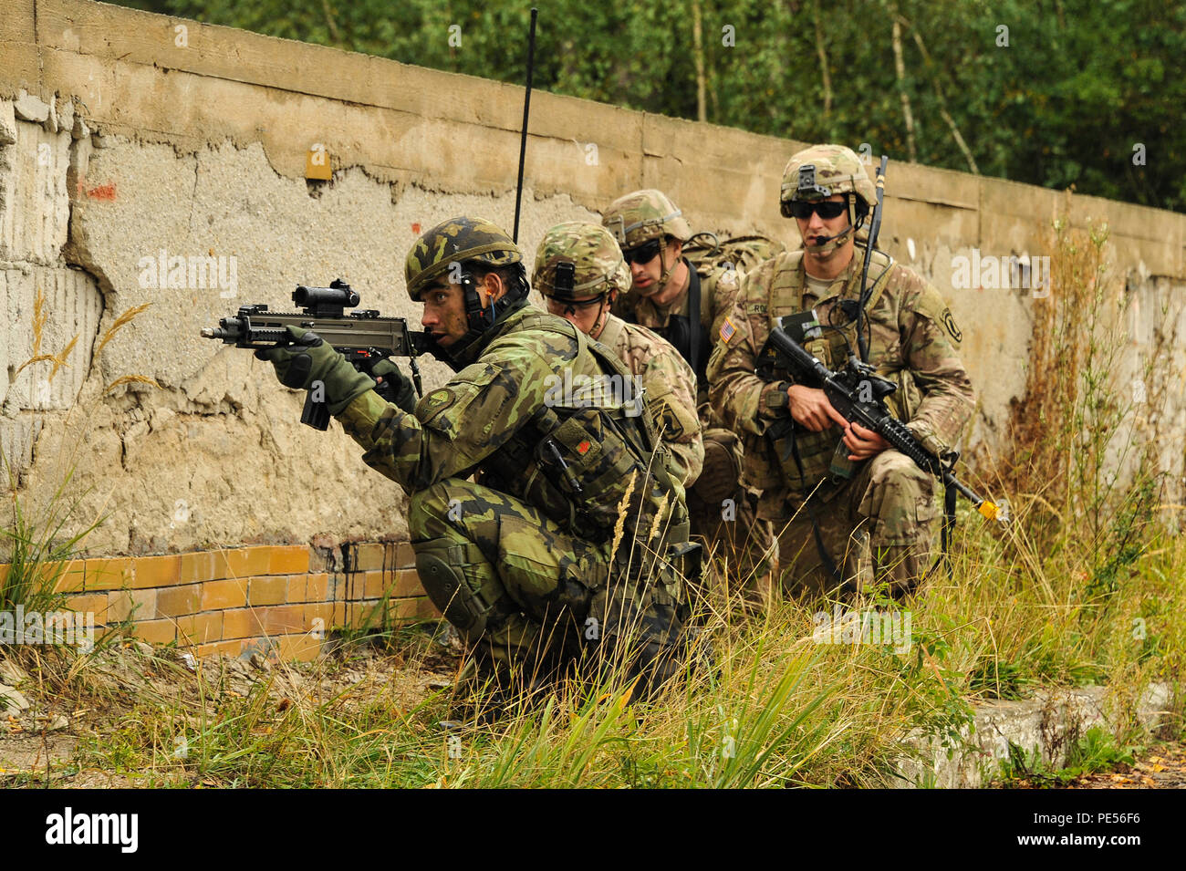 U.S. Army paratroopers, assigned to 1st Squadron, 91st Cavalry Regiment, 173rd Airborne Brigade and Czech army paratroopers, assigned to the 43rd Airborne Battalion, 4th Rapid Reaction Brigade, conduct an attack on urban terrain as part of Exercise Sky Soldier II at the Bechyne Training Area, Czech Republic, Sept. 23, 2015. Sky Soldier is a series of bilateral exercises between the 173rd Airborne and 4th Rapid Reaction Brigades designed to increase interoperability and strengthen partnerships between NATO airborne forces.  (U.S. Army photo by Visual Information Specialist Markus Rauchenberger/ Stock Photo