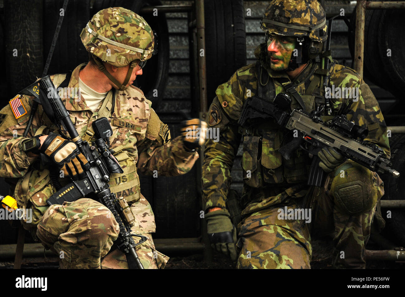 U.S. Army paratroopers, assigned to 1st Squadron, 91st Cavalry Regiment, 173rd Airborne Brigade, and Czech army paratroopers, assigned to the 43rd Airborne Battalion, 4th Rapid Reaction Brigade, conduct an attack on urban terrain as part of Exercise Sky Soldier II at the Bechyne Training Area, Czech Republic, Sept. 23, 2015. Sky Soldier is a series of bilateral exercises between the 173rd Airborne and 4th Rapid Reaction Brigades designed to increase interoperability and strengthen partnerships between NATO airborne forces. (U.S. Army photo by Visual Information Specialist Markus Rauchenberger/ Stock Photo