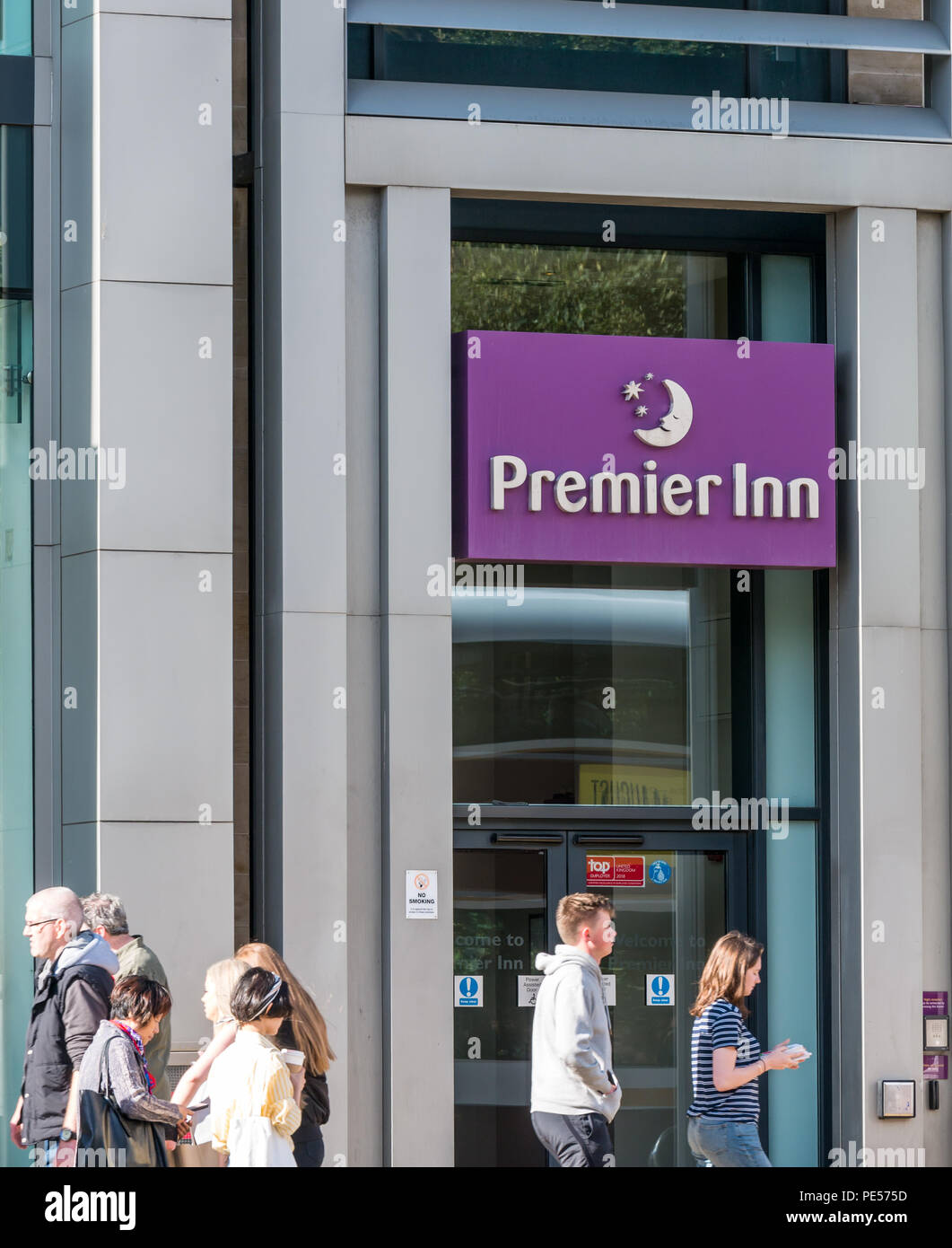 People walking past frontage of Premier Inn, Princes Street, Edinburgh, Scotland, UK on sunny Summer day Stock Photo
