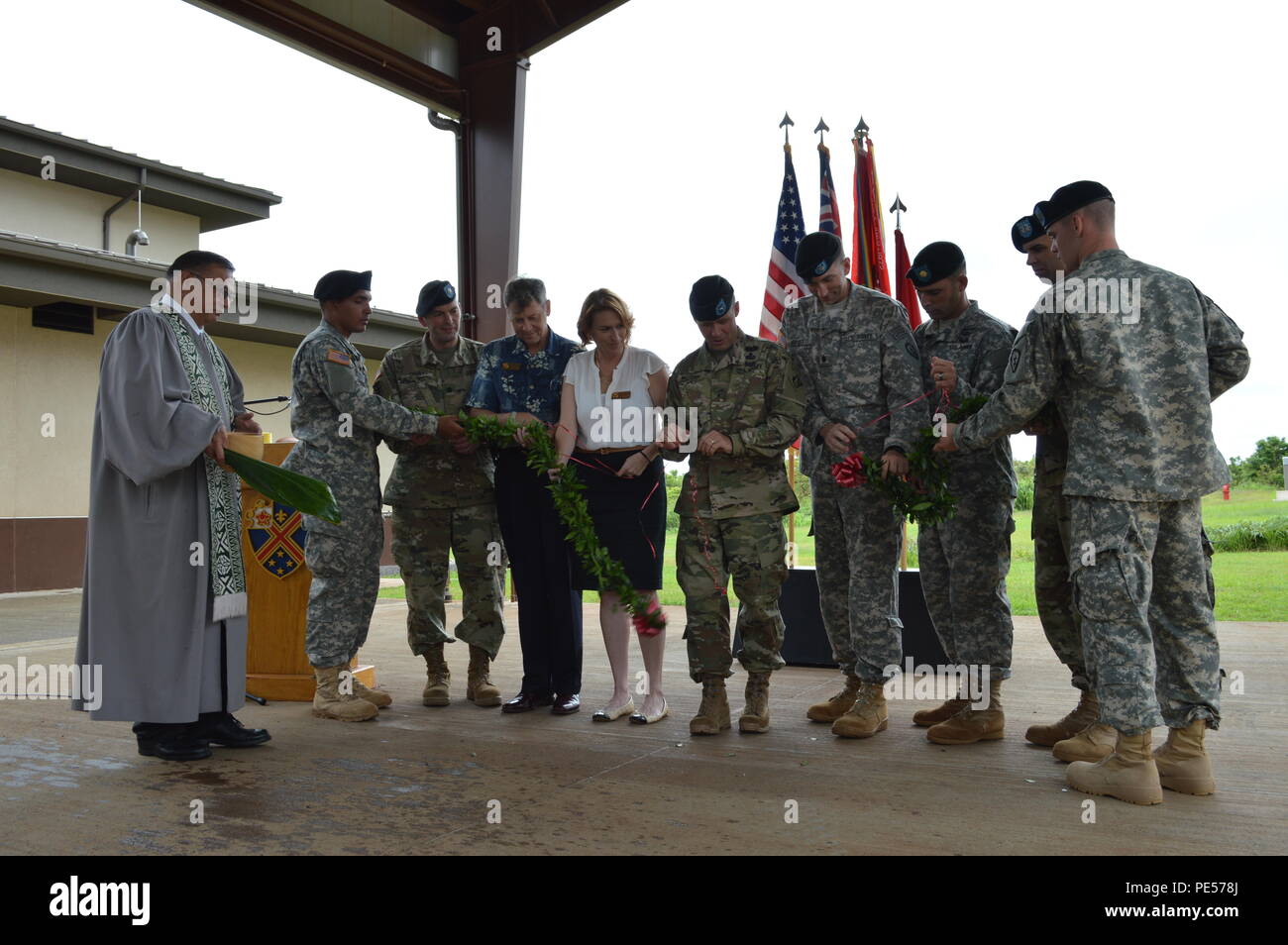 Brig. Gen. Jeffrey L. Milhorn, center, unties the maile lei during a