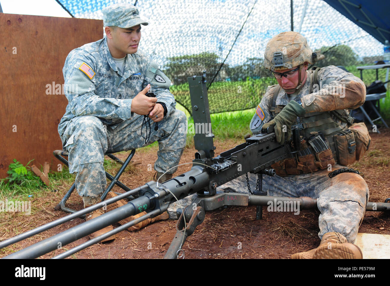 Sgt. Matthew Gallaway (right), an infantryman with Company A, 1st battalion, 27th Infantry Regiment, 2nd Stryker Brigade Combat Team, 25th Infantry Division, performs a functions check on a .50 caliber machine gun, Sept. 16, while graded by Staff Sgt. Johnathan Sablan (left), an infantryman with Company A, 1-27 IR, during the Expert Infantry Competition. Fifty Soldiers who competed in this iteration of the EIB competition earned the coveted badge. (U.S. Army photo by Sgt. Ian Ives, 2nd Stryker Brigade Combat Team Public Affairs/Released). Stock Photo