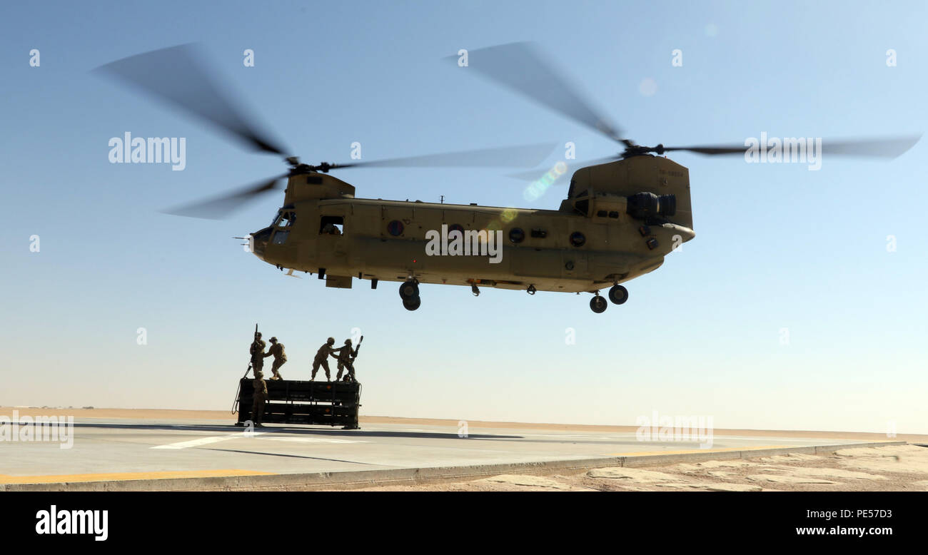 A CH-47 Chinook from the 2nd Battalion, 135th General Support Aviation Battalion, currently attached to the 185th Theater Aviation Brigade maneuvers into position during sling load training on Sept. 24, 2015, in Al Jaber, Kuwait. Having both aviation and ground assets at the same location allows for more training opportunities that reserve component units may not receive at home station. (U.S. Army National Guard photo by Staff Sgt. Michael Needham/Released) Stock Photo