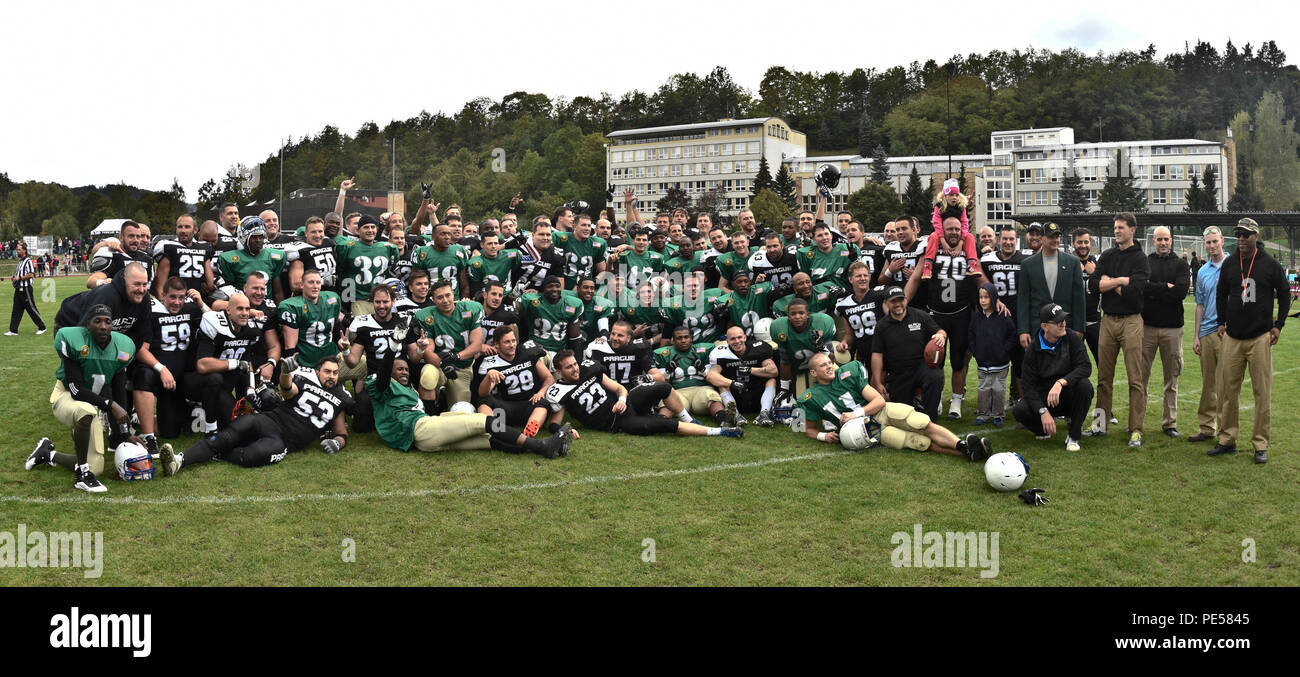 Troopers from the 2nd Cavalry Regiment Football Team celebrated their 35-0 victory alongside their on-field rivals, the Prague Black Panthers, after their football game in Cesky Krumlov, Czech Republic, Sept. 26, 2015. The team participated in an American football game with the local Czech Republic semi-professional football team as the unit helped to commemorate the 70th anniversary of Cesky Krumlov's liberation during World War II while also demonstrating the U.S. commitment to their NATO and Czech allies. (U.S. Army photo by Sgt. William A. Tanner/released) Stock Photo