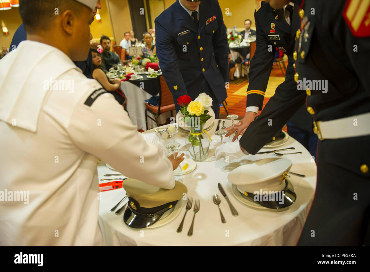 150925-N-HD670-284 OXNARD, Calif. (Sept. 25, 2015) - Service members participate in a Prisoner of War, Missing in Action (POW/MIA), observance during a military appreciation dinner. The 18th annual dinner, hosted by the Oxnard Chamber of Commerce, was held to recognize active duty and retired service members from the communities around Naval Base Ventura County. (U.S. Navy photo by Utilitiesman 3rd Class Stephen Sisler/Released) Stock Photo
