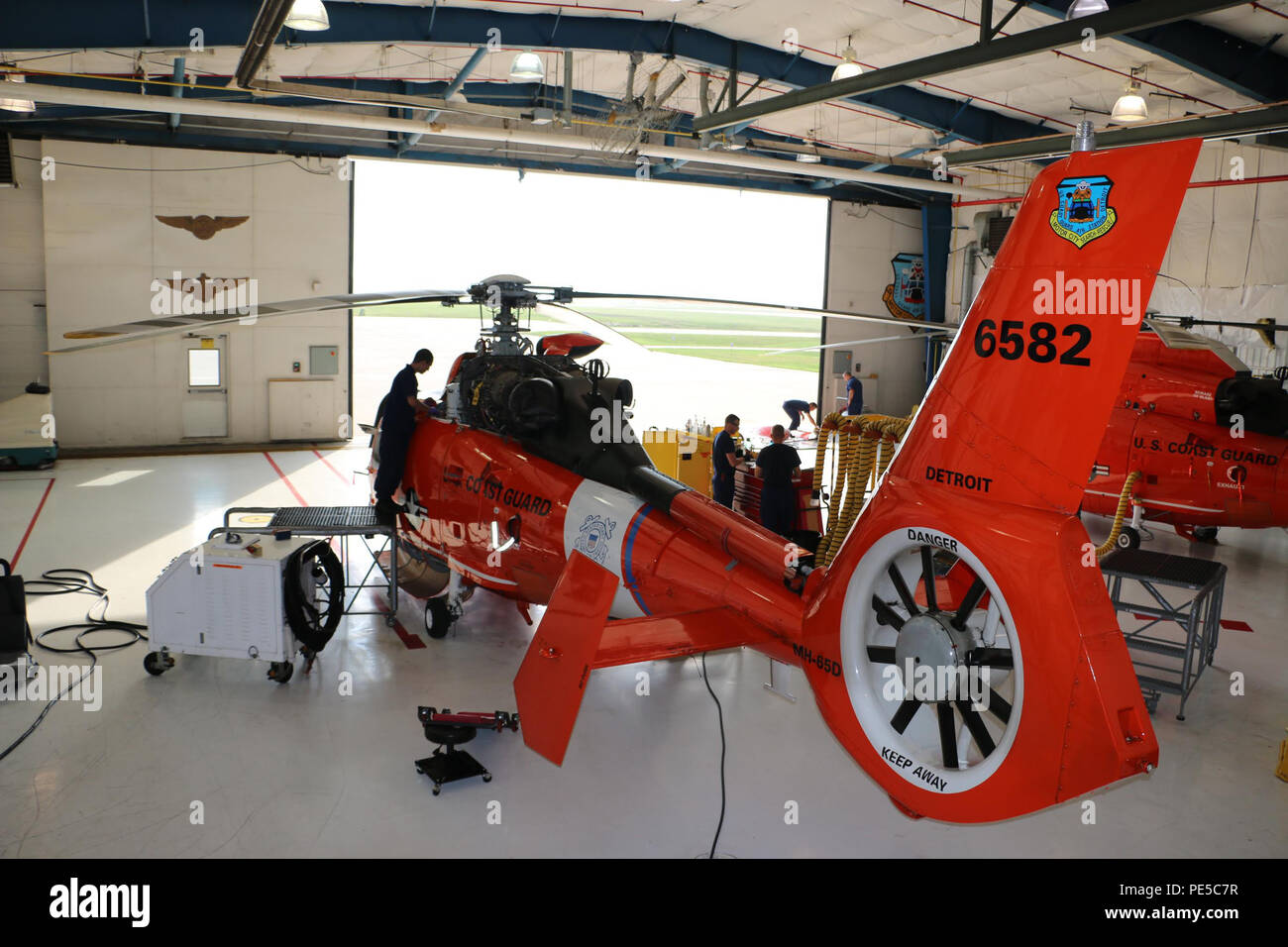 A crew from Coast Guard Air Station Detroit performs an hourly inspection and maintenance on an