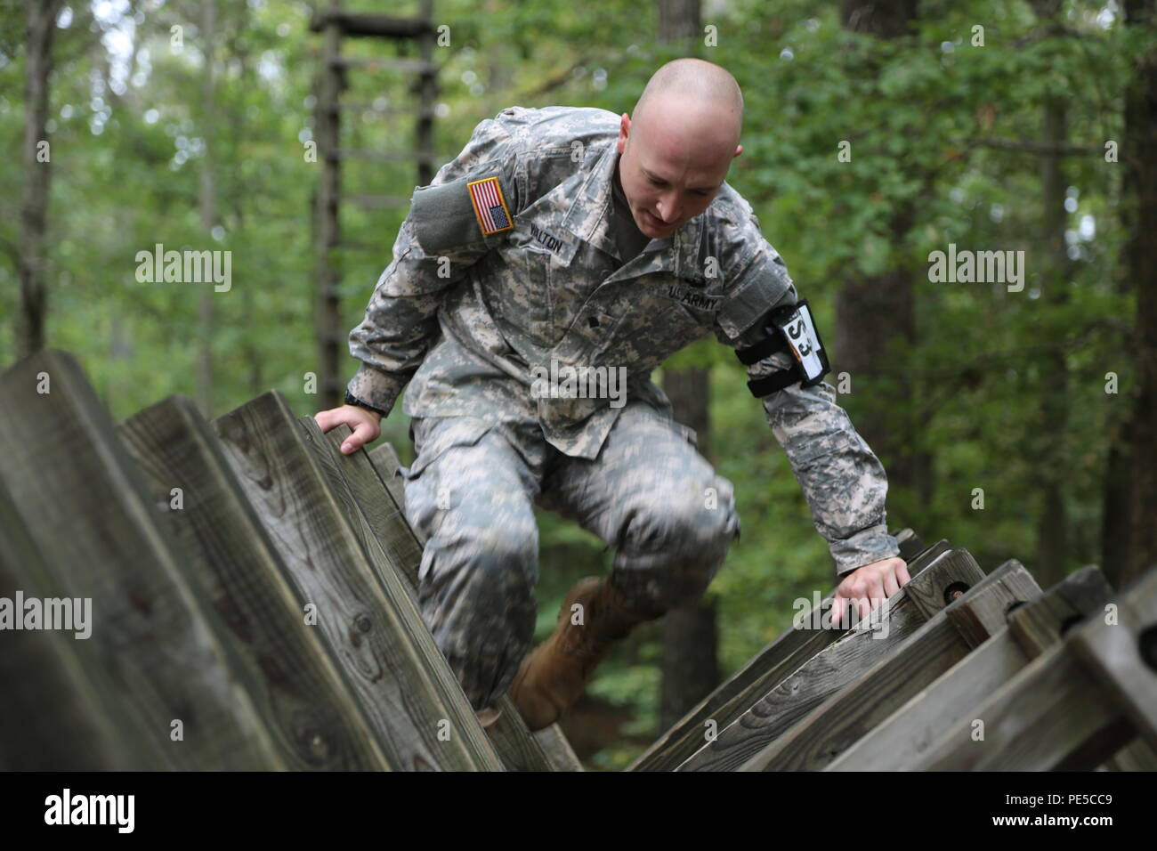 U.S. Army Spc. Adam Walton, assigned to AMC Band, U.S. Army Material Command, navigates an obstacle course as part of the U.S. Army's Best Warrior Competition at Fort A.P. Hill, Va., Oct. 5, 2015. The competition is a grueling, weeklong event that tests the skills, knowledge and professionalism of 26 warriors representing 13 commands. (U.S. Army photo by Spc. Hayley Gardner/Released) #BestWarrior Stock Photo
