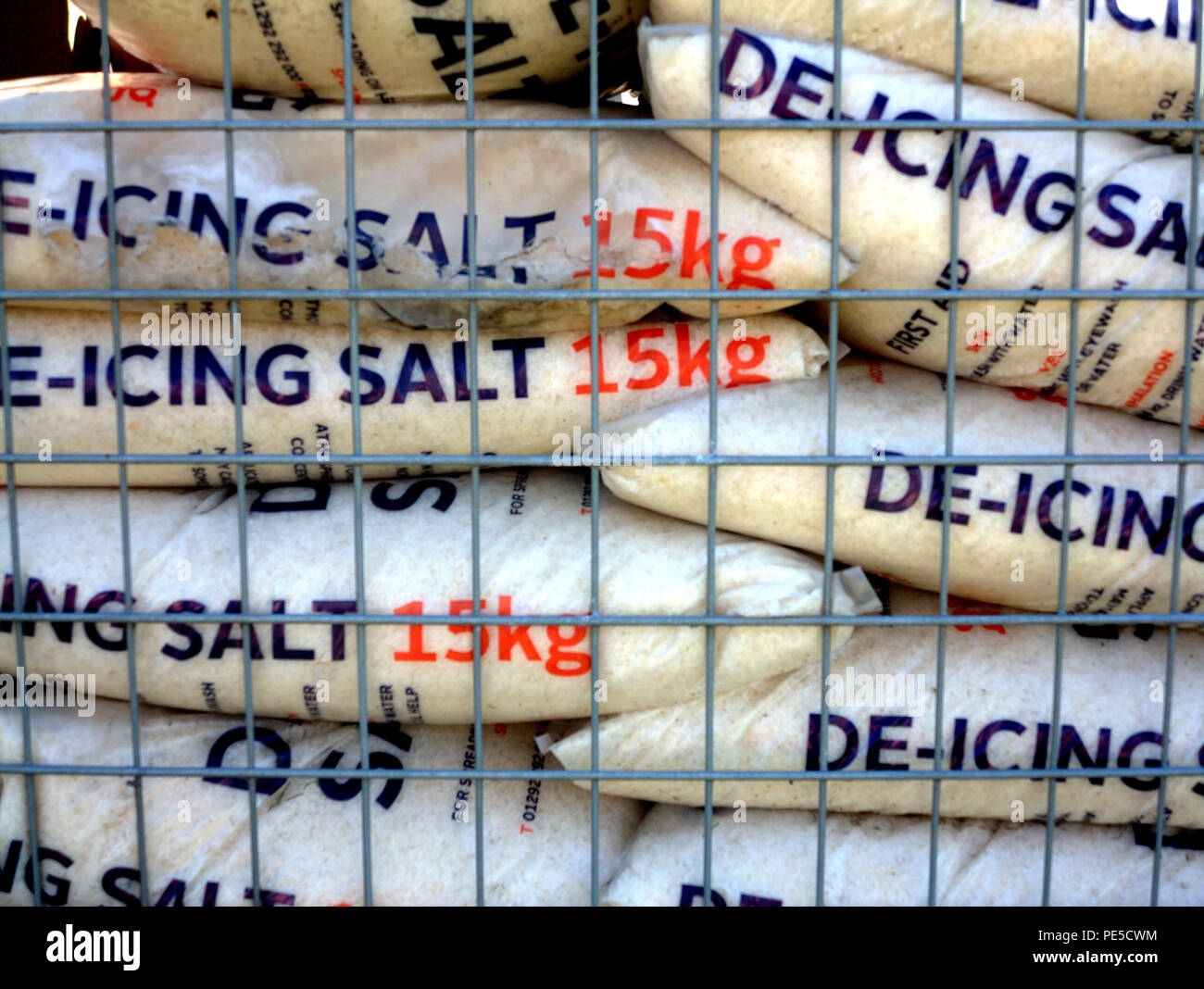 de-icing rock salt 15 kilogram bags in cage Stock Photo