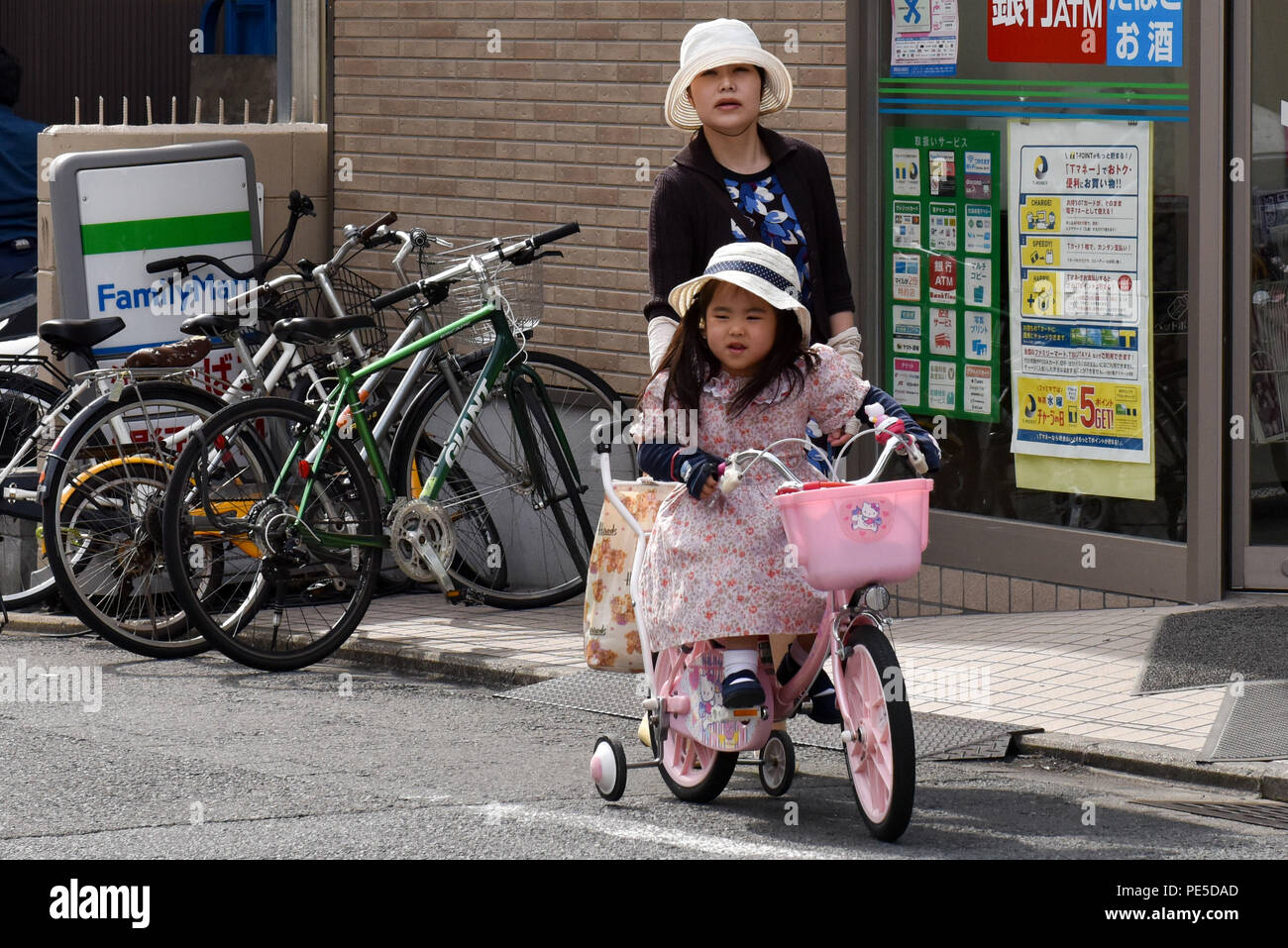 Girl learning to bike, Kyoto, Japan Stock Photo