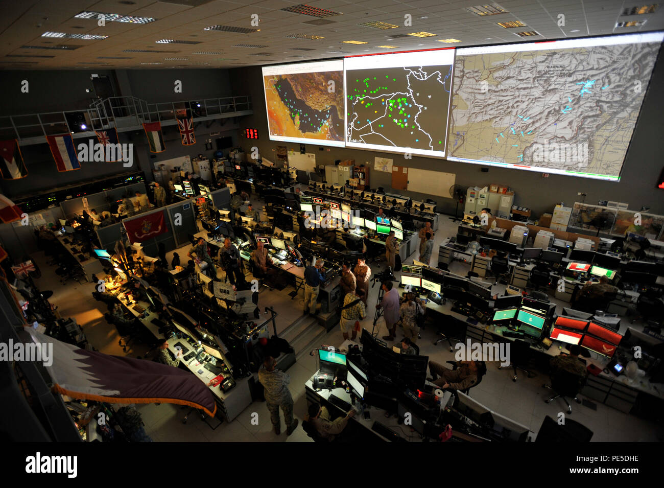 Combined Air Operations Center (CAOC) at Al Udeid Air Base, Qatar, provides command and control of air power throughout Iraq, Syria, Afghanistan, and 17 other nations.  The CAOC is comprised of a joint and coalition team that executes day-to-day combined air and space operations and provides rapid reaction, positive control, coordination, and de-confliction of weapon systems. (U.S. Air Force photo by Tech. Sgt. Joshua Strang) Stock Photo