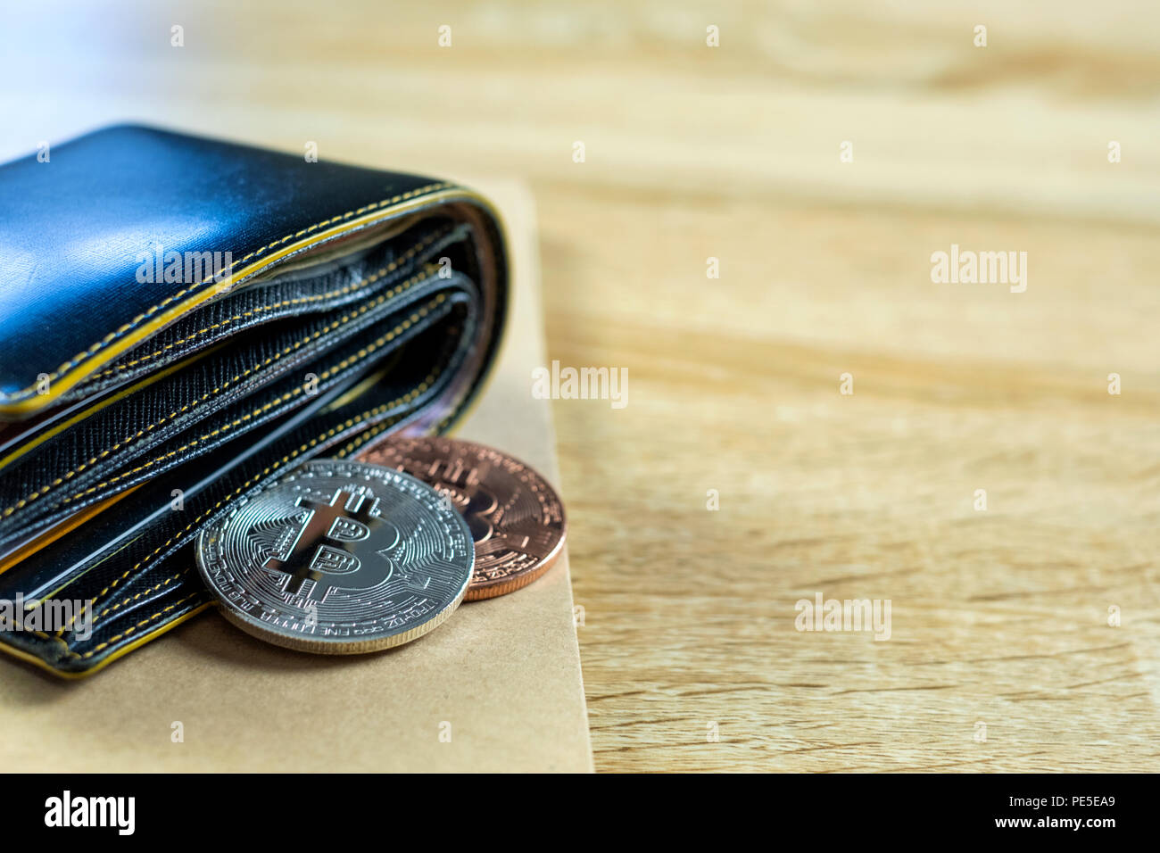 Bitcoin digital currency instead real money, bit-coin with leather wallet  or purse on wooden working table, virtual cryptocurrency money business  conc Stock Photo - Alamy