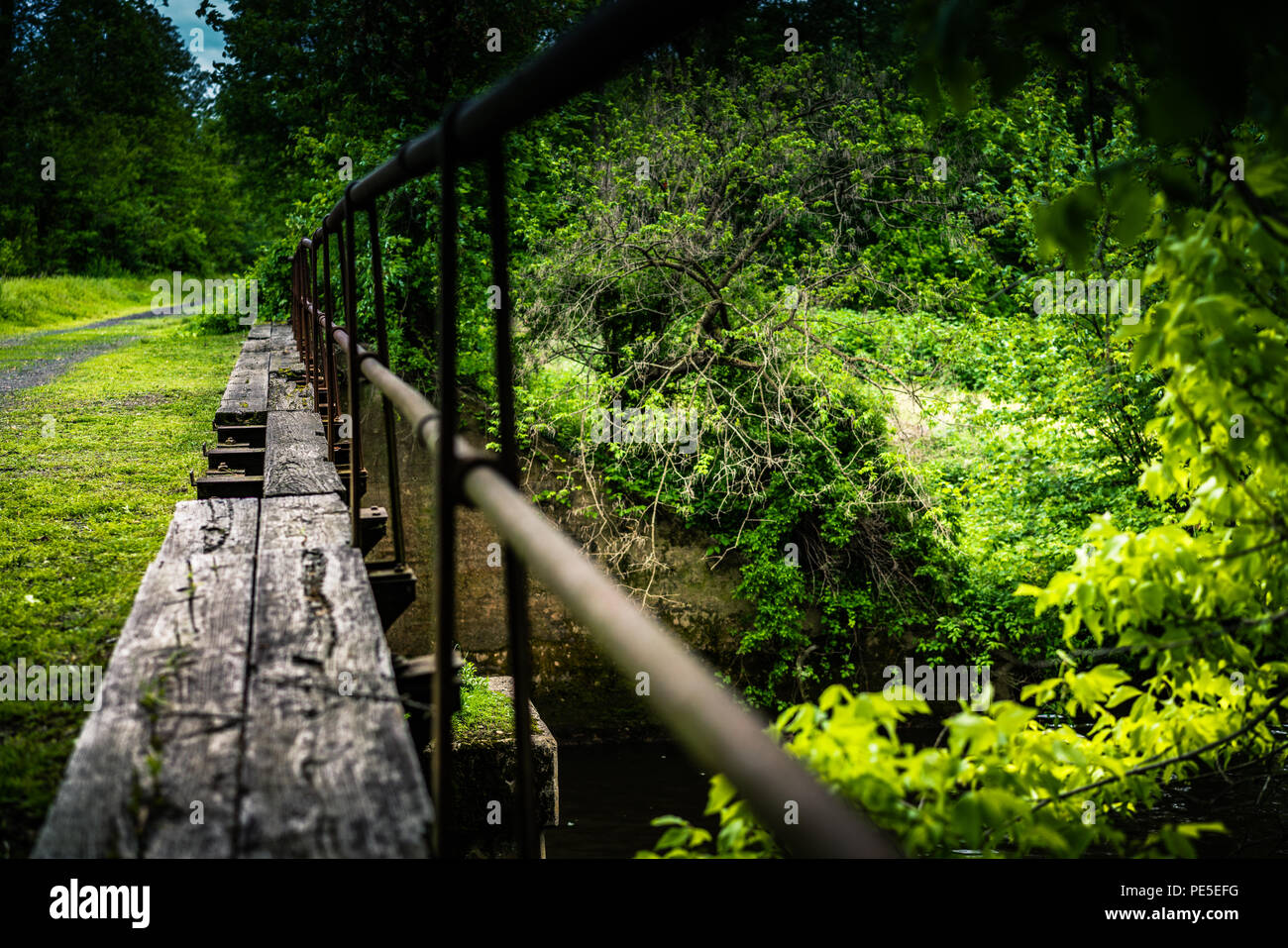 Old canal bridge leading away. Stock Photo