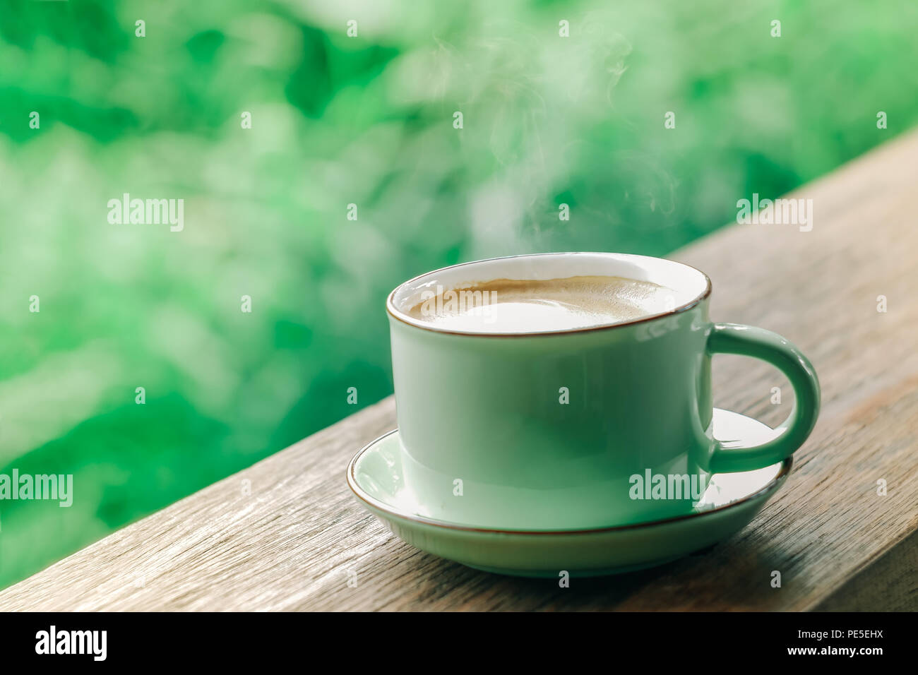 hot coffee cup on natural green background Stock Photo
