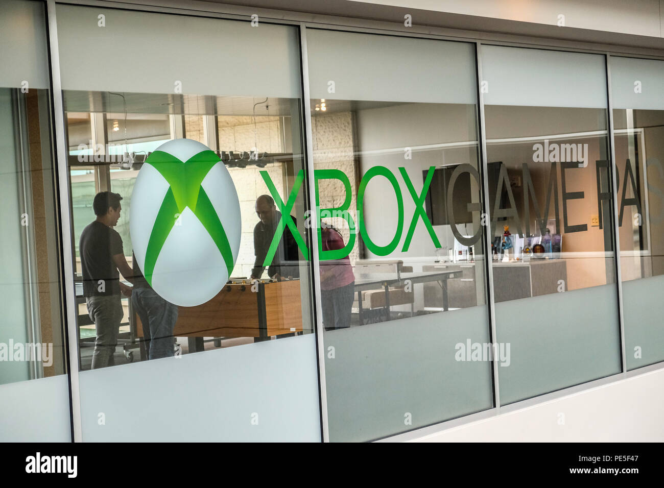 Employees playing ping pong game and Xbox logo on windows Inside the  Microsoft Xbox office building Stock Photo - Alamy