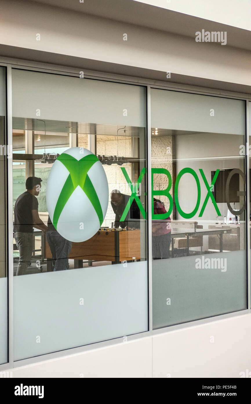 Employees playing ping pong game and Xbox logo on windows Inside the Microsoft Xbox office building Stock Photo