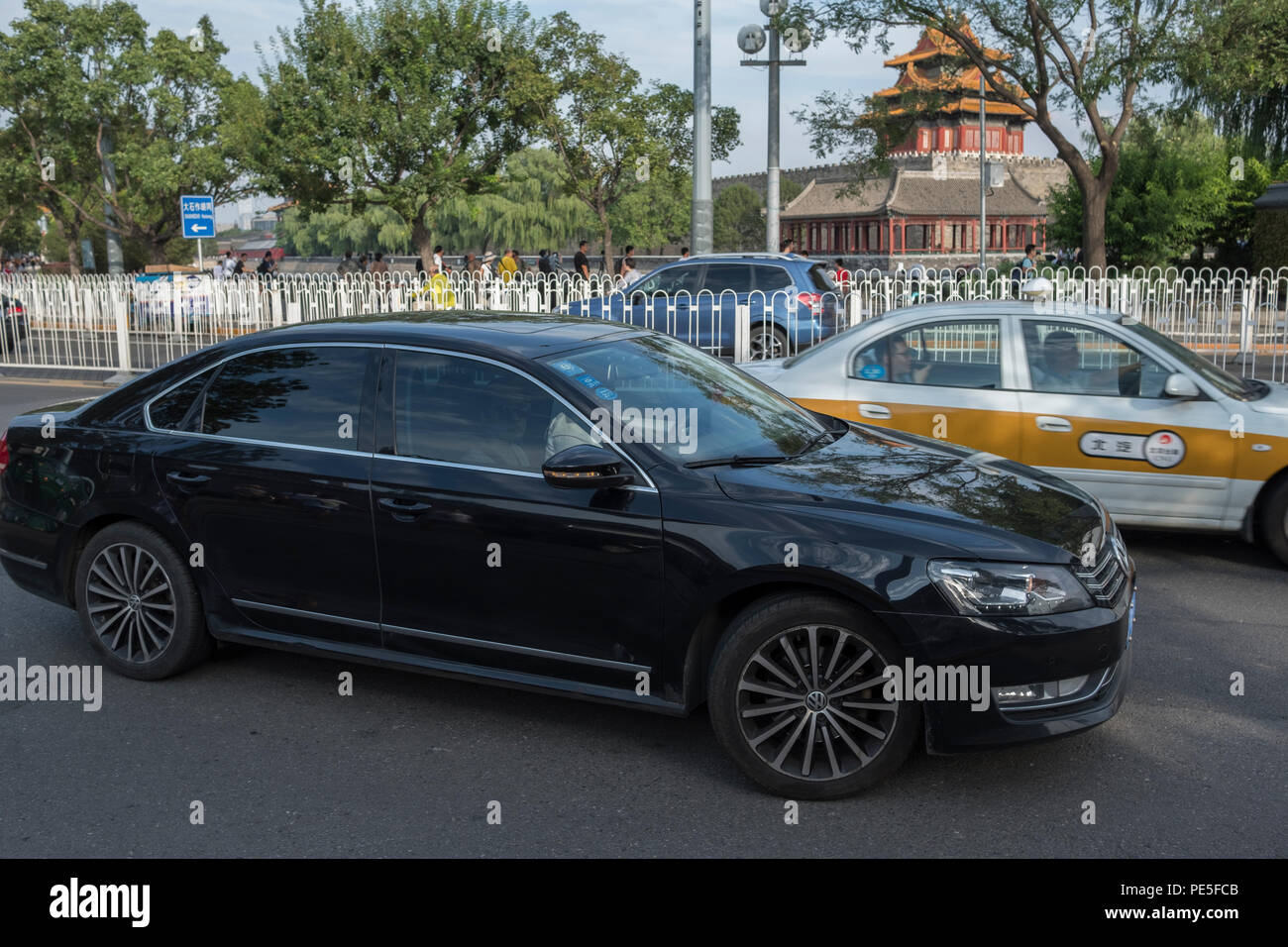 A Didi Premier car drives past the Forbidden City in central Beijing, China. Didi Premier offers a higher-end premier mobility experience with luxury  Stock Photo
