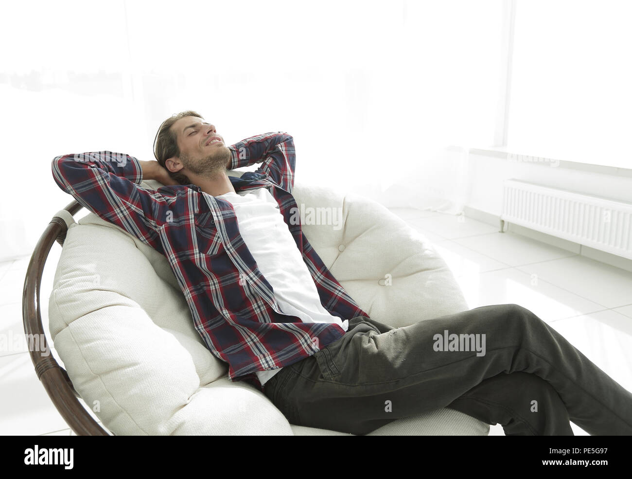 Resting In Chair modern guy is resting sitting in a large comfortable chair. side view ...