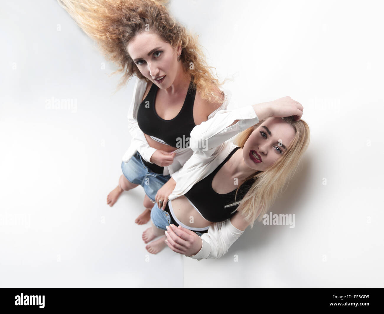 two frustrated women standing near the walls Stock Photo