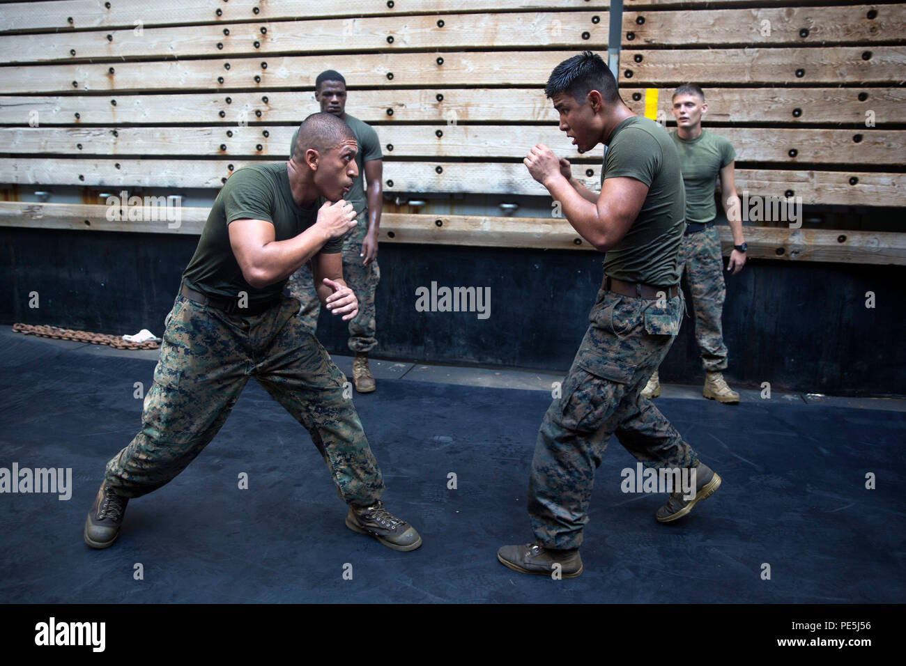 GULF OF ADEN (Oct. 17, 2015)  Marine Sgt. Marcos Gonzalez, left, spars  with Lance Cpl. Giovanni Carrera during the combat conditioning portion of  a Marine Corps Martial Arts Program black belt
