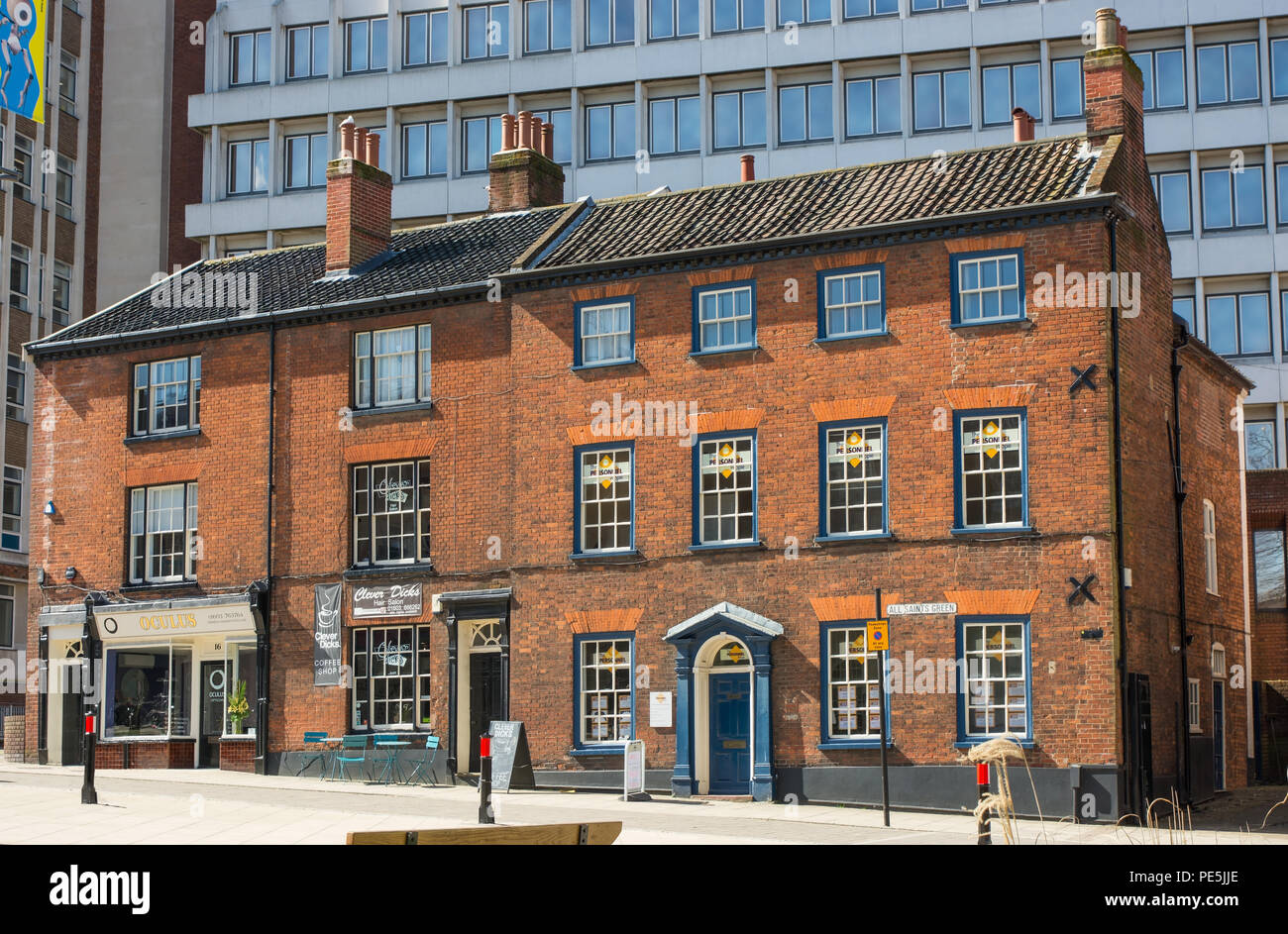 Old brick buildings surrounded by modern buildings in All Saints Green