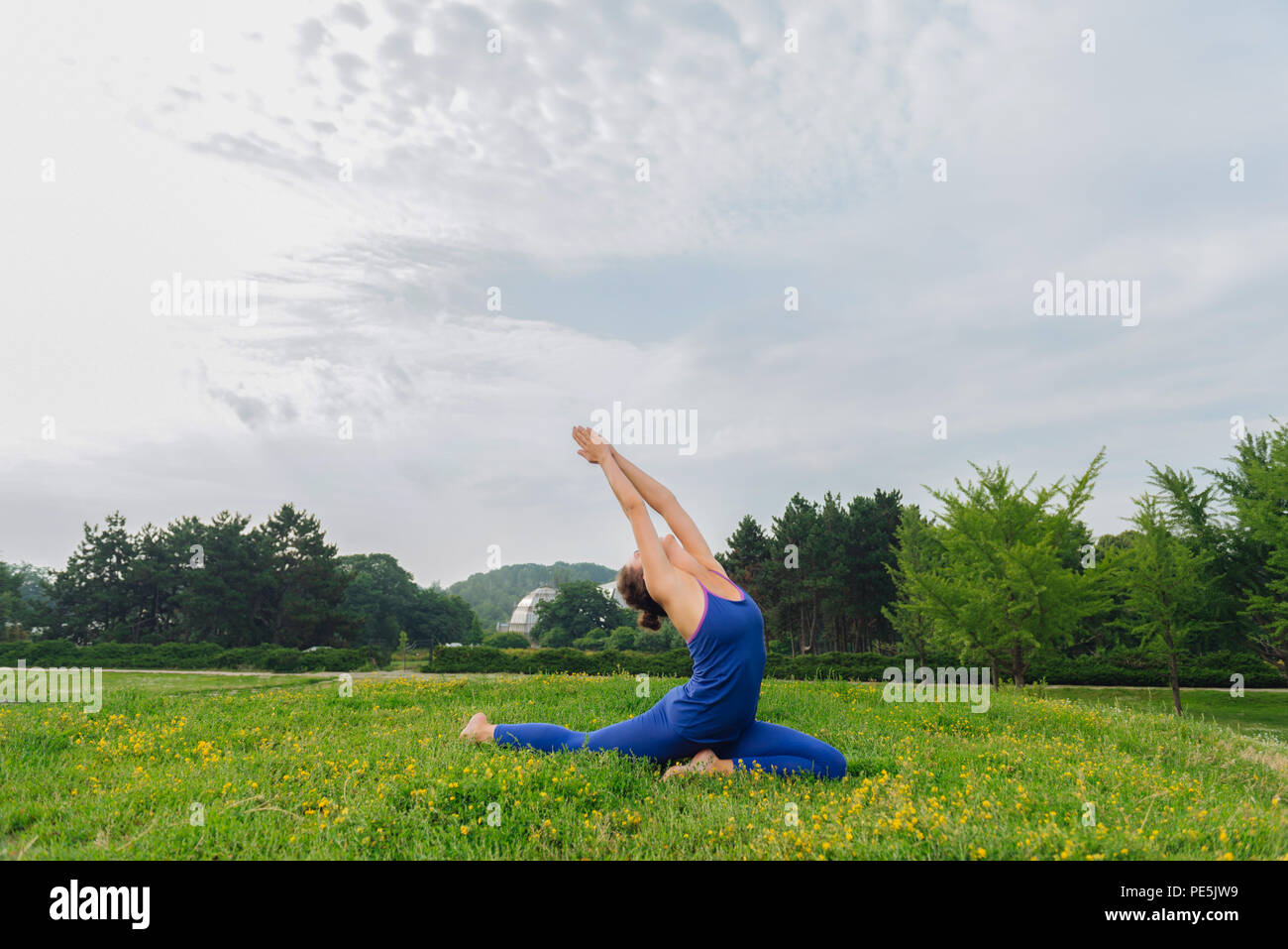 Slim woman having good mood while doing morning yoga Stock Photo