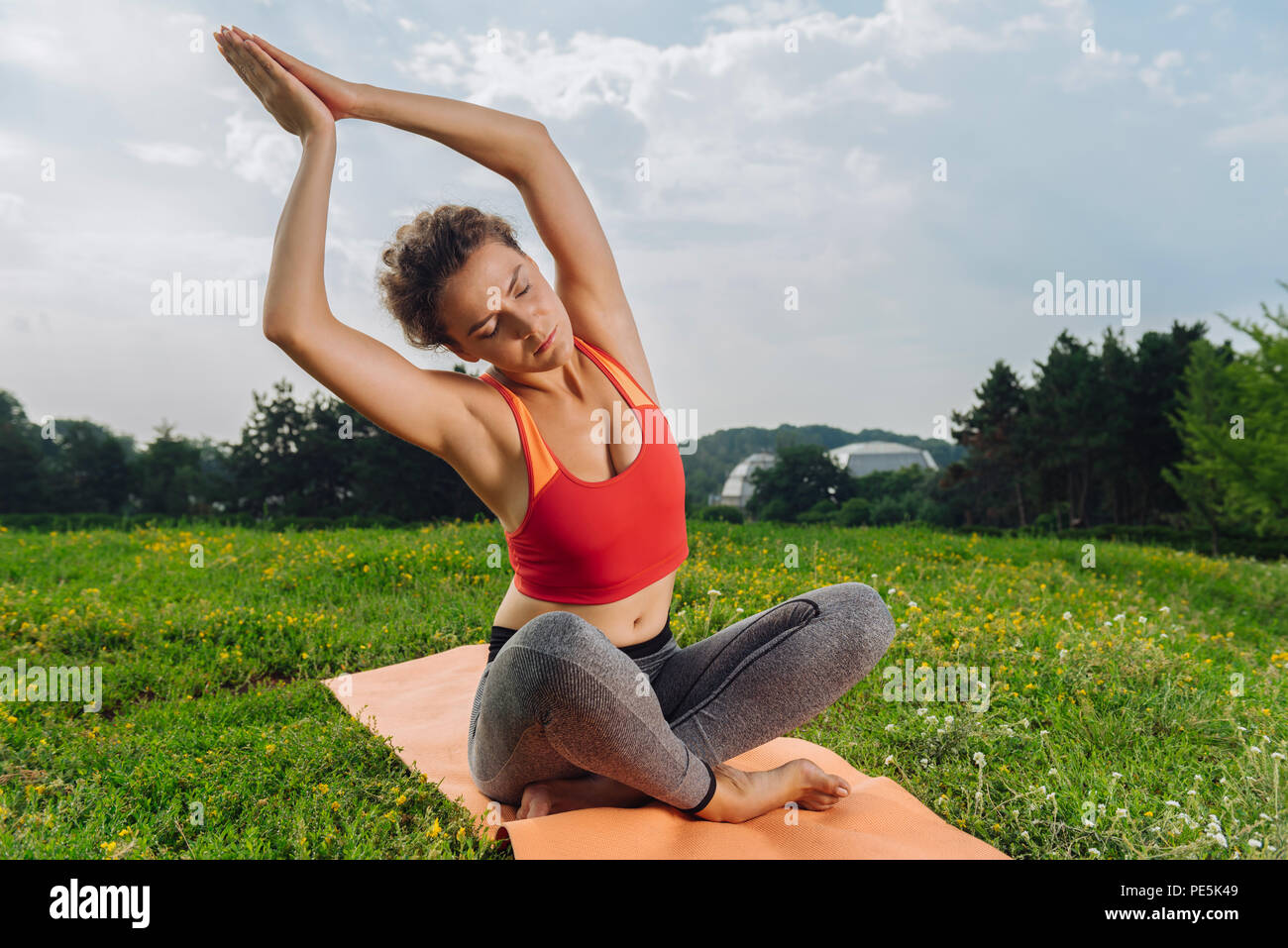 Dark-haired yoga woman stretching to the right side Stock Photo