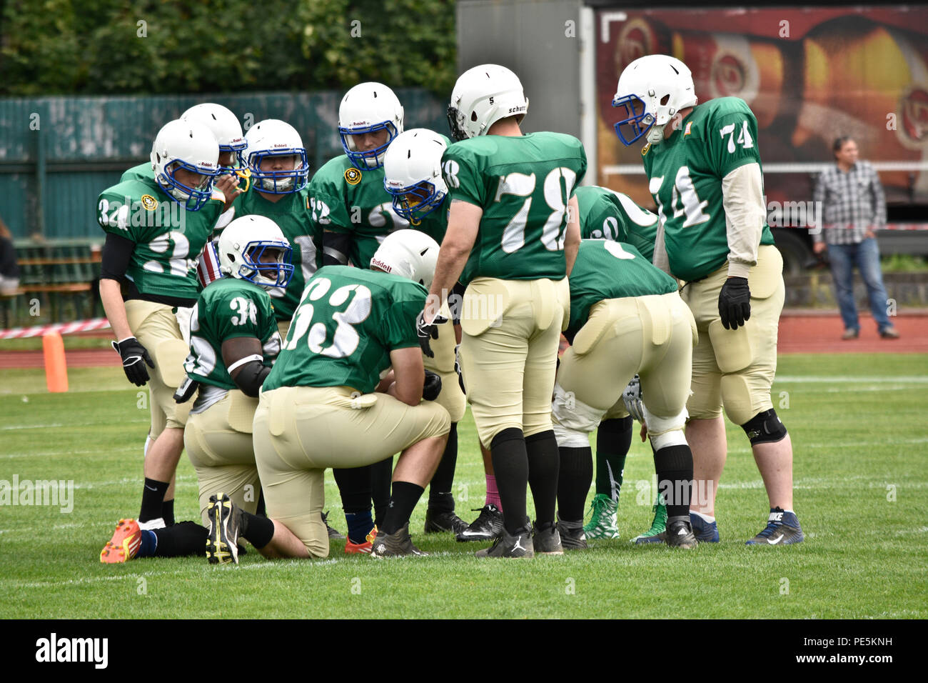 Offensive players from the 2nd Cavalry Regiment's football team huddle together for the first play of their game against the Prague Black Panthers in Cesky Krumlov, Czech Republic, Sept. 26, 2015. The team participated in an American football game with the local Czech Republic semi-professional football team as the unit helped to commemorate the 70th anniversary of Cesky Krumlov's liberation during World War II while also demonstrating the U.S. commitment to their NATO and Czech allies. (U.S. Army photo by Sgt. William A. Tanner/released) Stock Photo