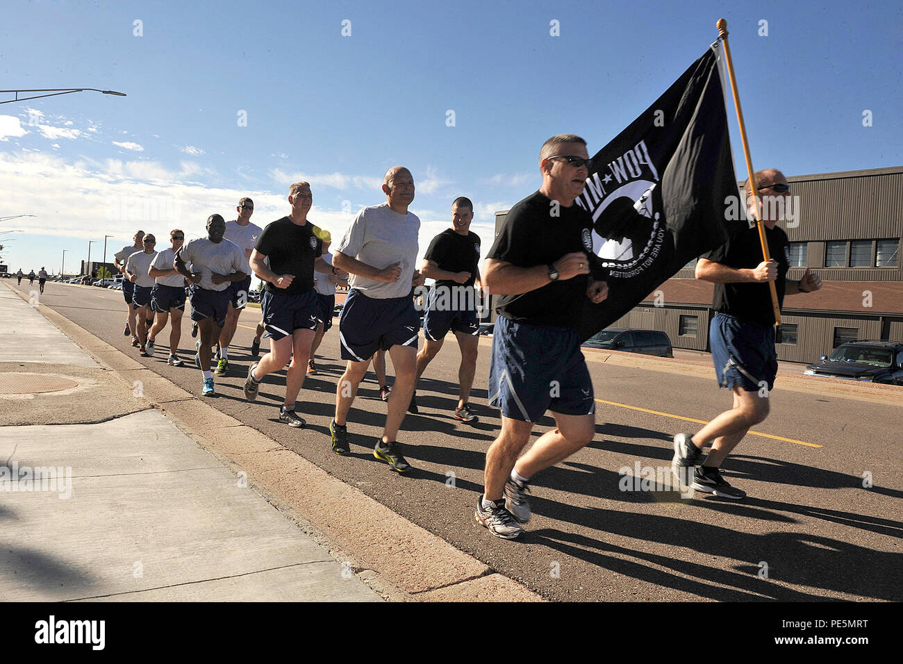 Col. Douglas Schiess, 21st Space Wing commander (right) and Col. Eric Dorminey, 21st Space Wing vice commander (left), lead the first leg of the POW/MIA 24-hour run here Sept. 17, 2015. Stock Photo