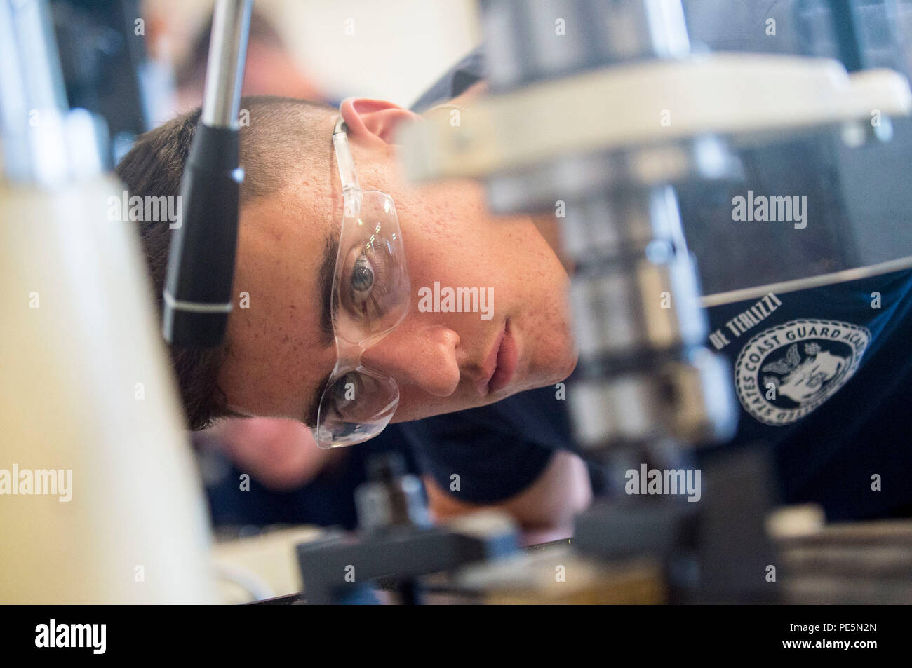 U.S. Coast Guard Academy cadets engage with a lathe machine for civil ...