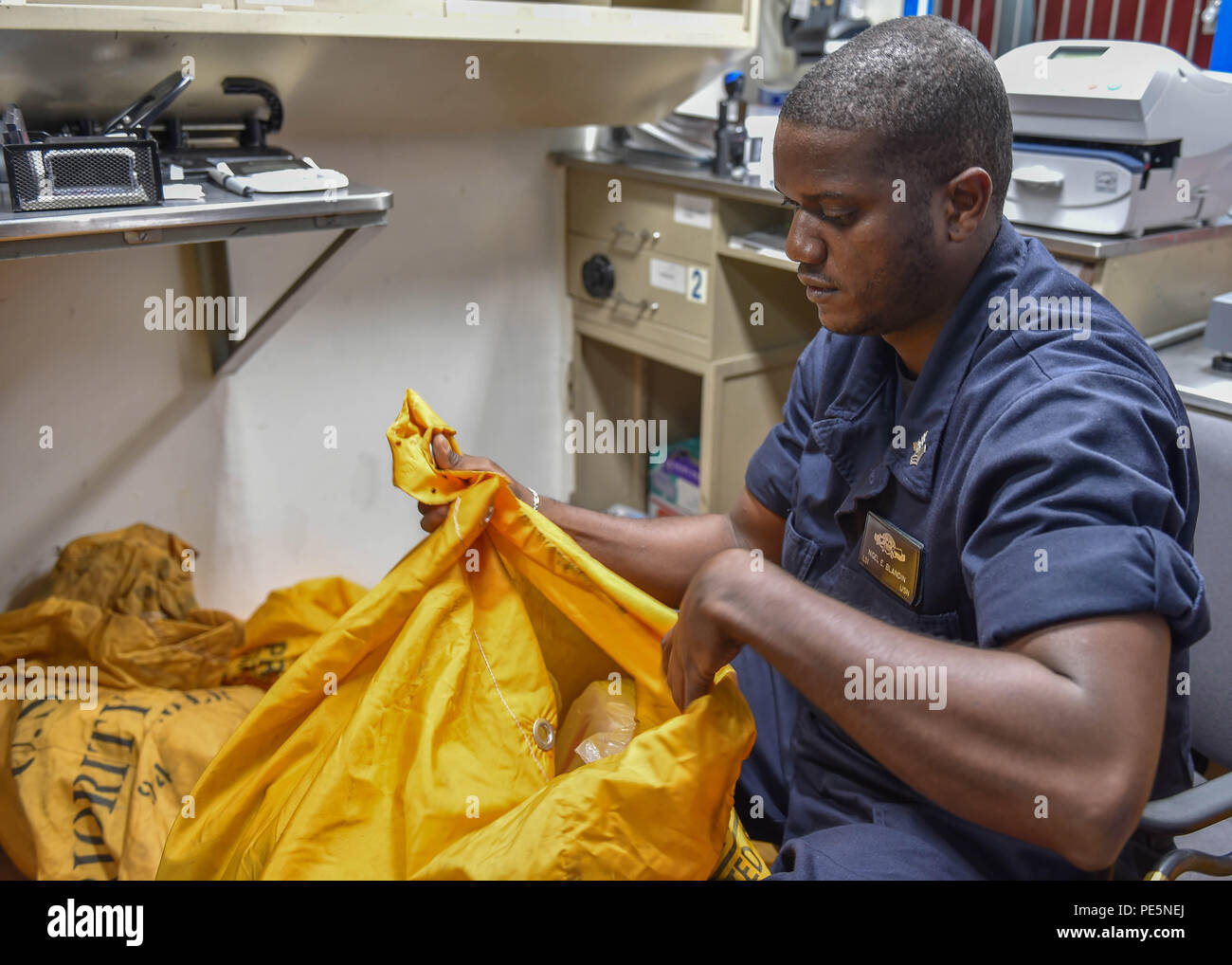 150924-N-UL721-053 SOUTH CHINA SEA (Sep. 24, 2015) U.S. Navy Sailor  Logistics Specialist 1st Class Nigel E. Blandin from Elizabeth, N.J.  prepares outgoing mail aboard the Arleigh Burke-class guided missile  destroyer USS Lassen (