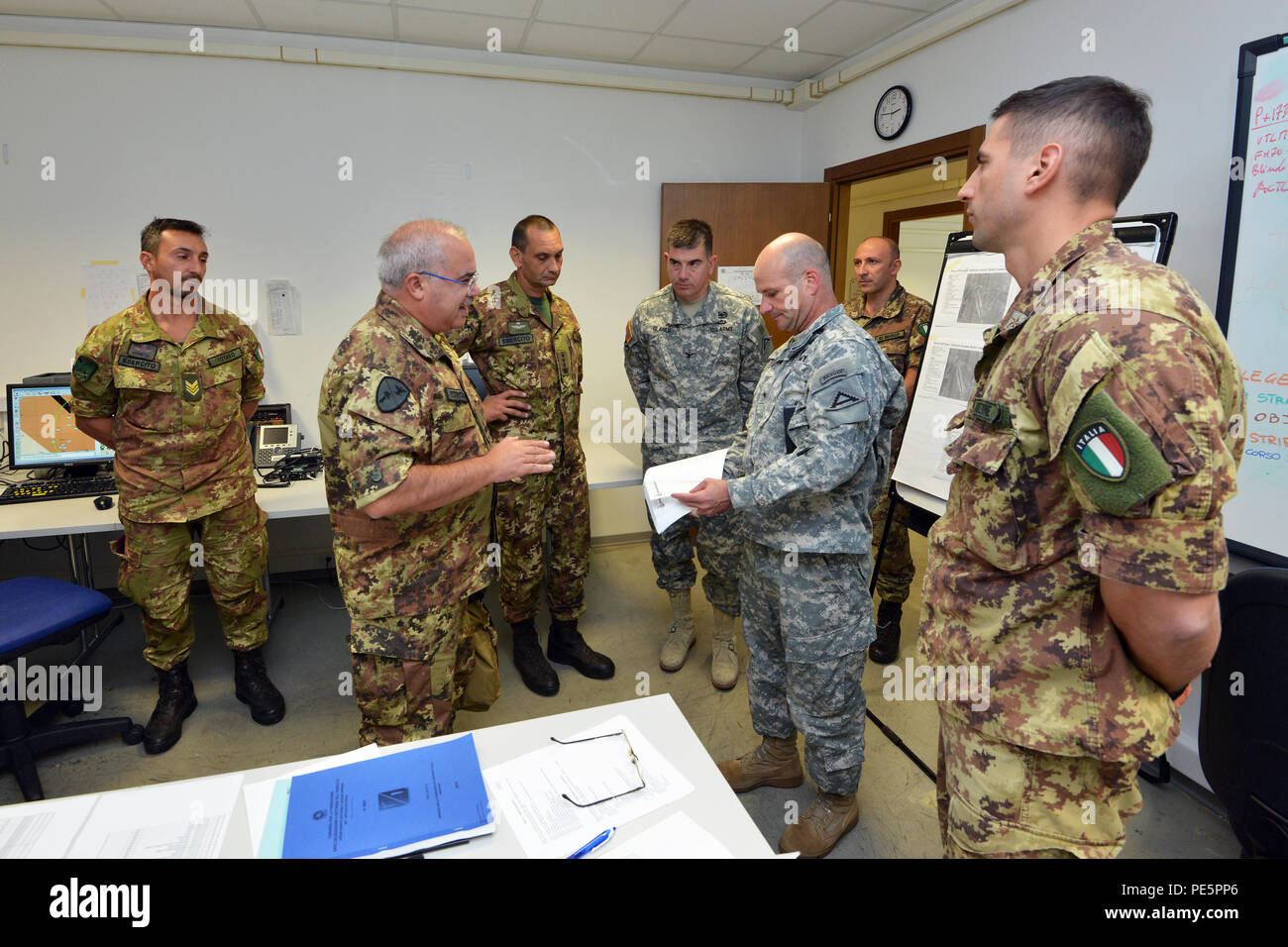 Brig. Gen. Salvatore Polimeno, commander of CE.SI.VA and Brig. Gen. Christopher G. Cavoli, commander of the 7th Army Joint Multinational Training Command, talk about NIE 16.1 (Network Integration Evaluation 16.1) exercise with U.S. and Italian Soldiers at Caserma Ederle Vicenza, Italy, Sept. 28, 2015. The NIE 16.1 is a multi-nation exercise designed to increase interoperability and communication between U.S. and NATO Friendly Force. (U.S. Army photo by Visual Information Specialist Paolo Bovo/released) Stock Photo
