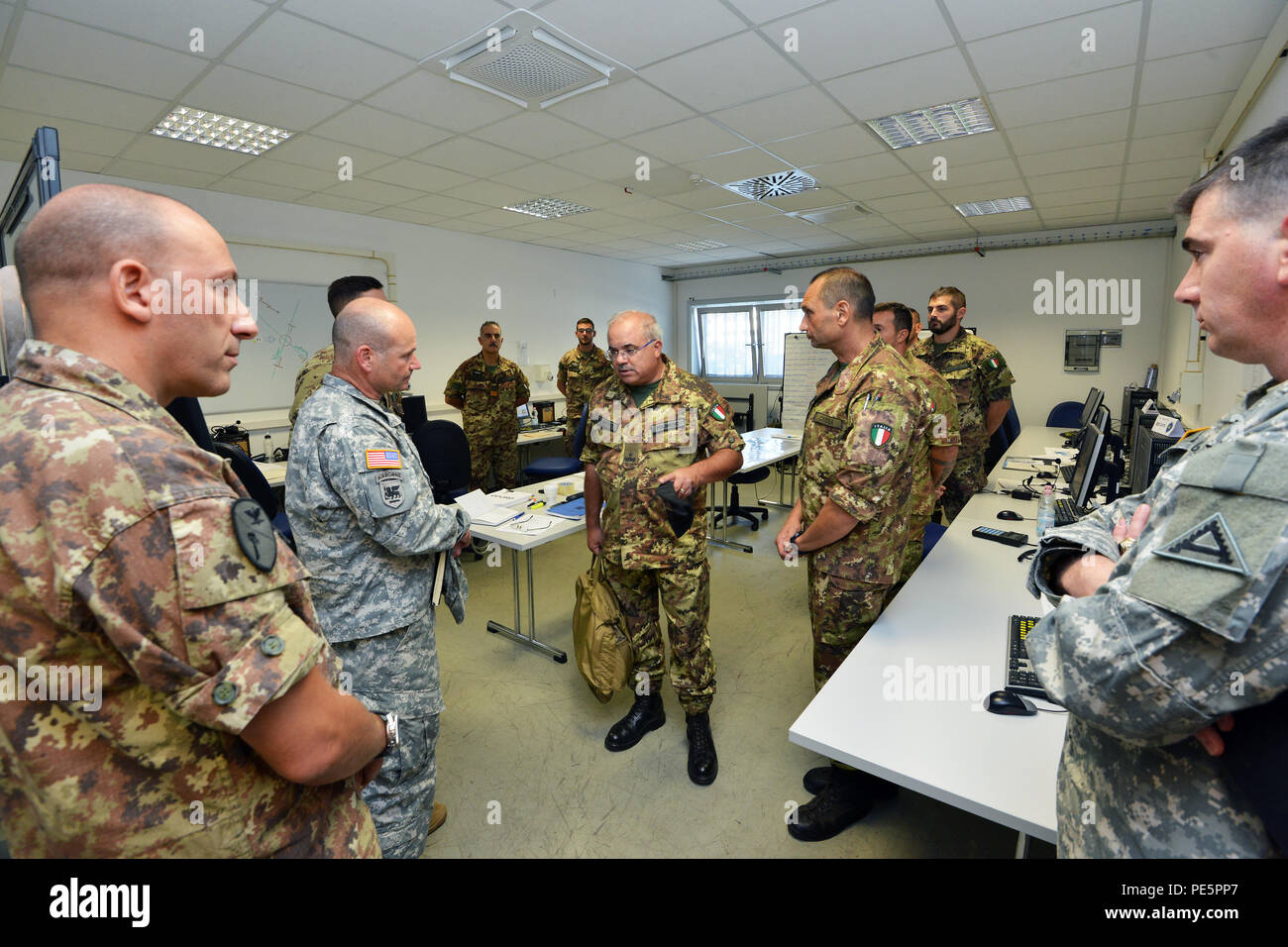 Brig. Gen. Salvatore Polimeno, commander of exercise CE.SI.VA and Brig. Gen. Christopher G. Cavoli, commander of the 7th Army Joint Multinational Training Command, talk about NIE 16.1 (Network Integration Evaluation 16.1) exercise with U.S. and Italian Soldiers at Caserma Ederle Vicenza, Italy, Sept. 28, 2015. The NIE 16.1 is a multi-nation exercise designed to increase interoperability and communication between U.S. and NATO Friendly Force. (U.S. Army photo by Visual Information Specialist Paolo Bovo/released) Stock Photo