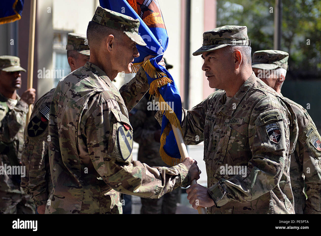 At a ceremony in Kabul, Afghanistan, Gen. John F. Campbell, commander, Resolute Support, passes the unit colors to Maj. Gen. Gordon 'Skip' Davis, in-coming commander, during the change of command for Combined Security Transition Command - Afghanistan on Oct. 1, 2015. Maj. Gen. Todd T. Simonite relinquished command.  The event was attended by an international audience representing NATO and coalition parter countries participating in the Resolute Support mission. (Military photo by Air Force Tech. Sgt. Robert Sizelove) Stock Photo