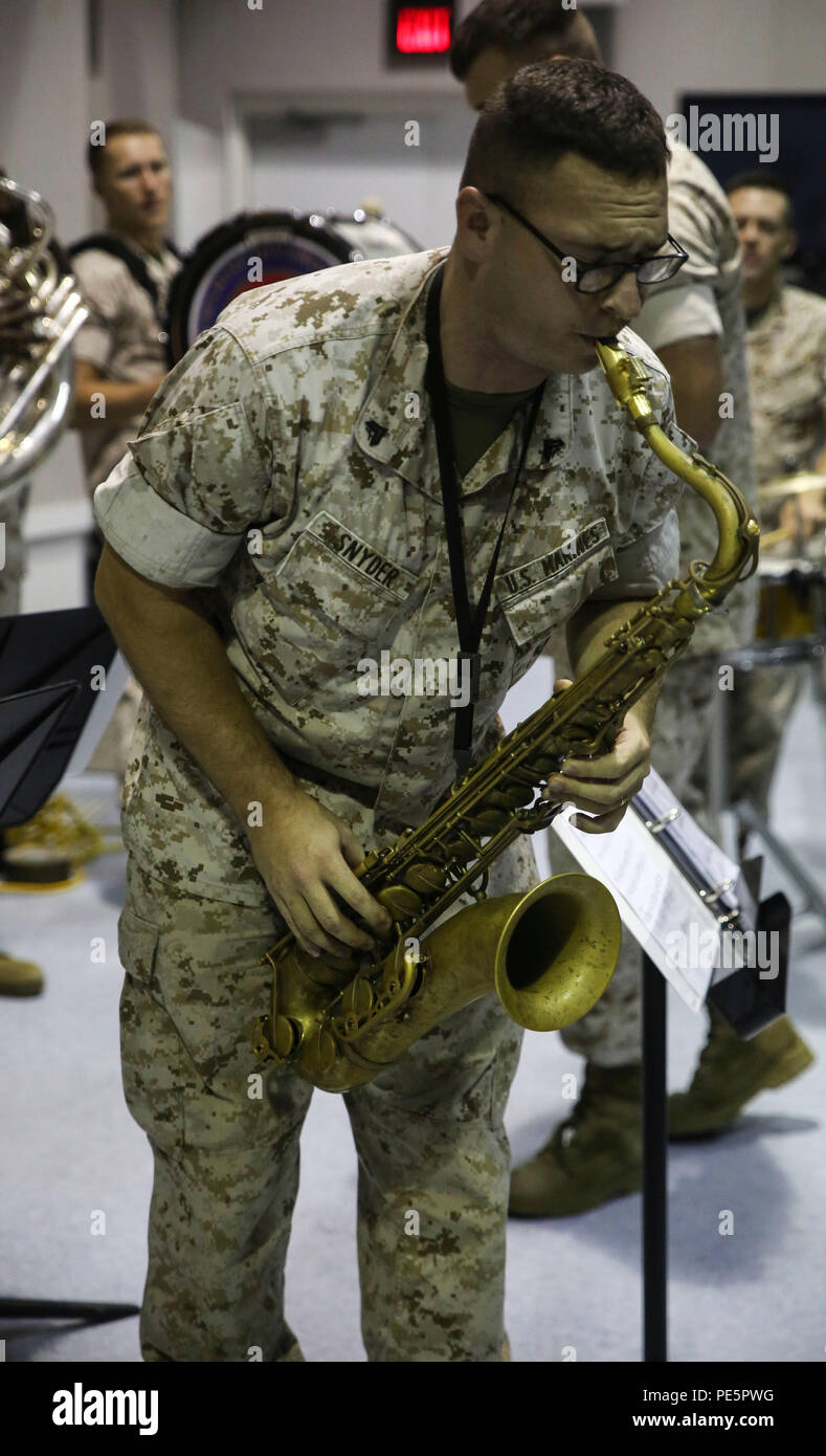 Cpl. Codie N. Snyder, a saxophonist with the 2nd Marine Division Band, plays for Amber N. Carter, a resident of Hubert, N.C., during her visit to the band’s command post at Camp Lejeune, N.C., Sept. 29, 2015. Amber always dreamed of joining the Marine Corps, but could not due to William’s syndrome. Staff Sgt. Isaiah Riley, a mess chief with 10th Marine Regiment, brought her and her family aboard the base to watch the band play. (U.S. Marine Corps photo by Cpl. Paul S. Martinez/Released) Stock Photo