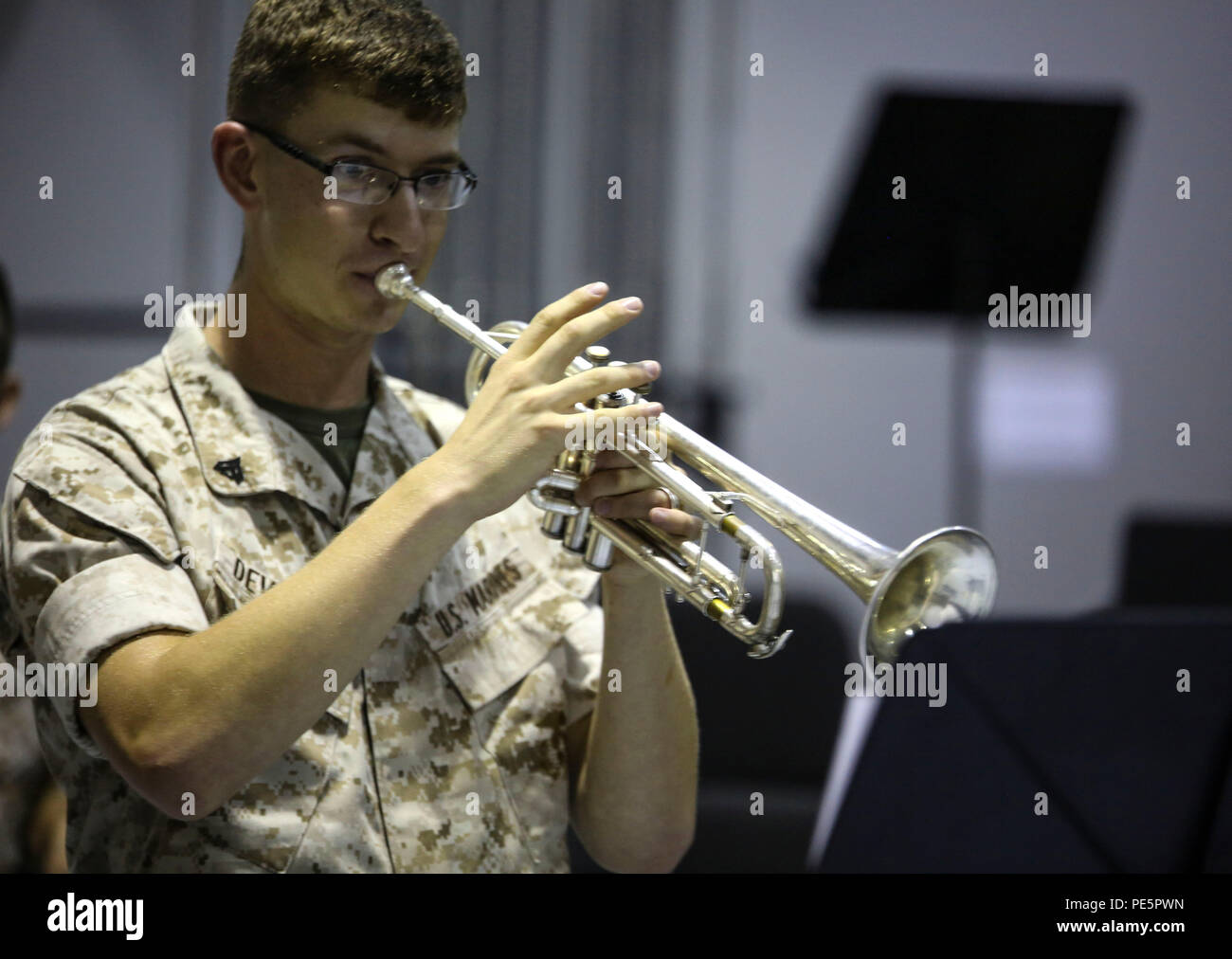 Cpl. Lucas T. Devalder, a trumpeter with the 2nd Marine Division Band plays for Amber N. Carter, a resident of Hubert, N.C., during her visit to the band’s command post at Camp Lejeune, N.C., Sept. 29, 2015. Amber always dreamed of joining the Marine Corps, but could not due to William’s syndrome. Staff Sgt. Isaiah Riley, a mess chief with 10th Marine Regiment, brought her and her family aboard the base to watch the band play. (U.S. Marine Corps photo by Cpl. Paul S. Martinez/Released) Stock Photo