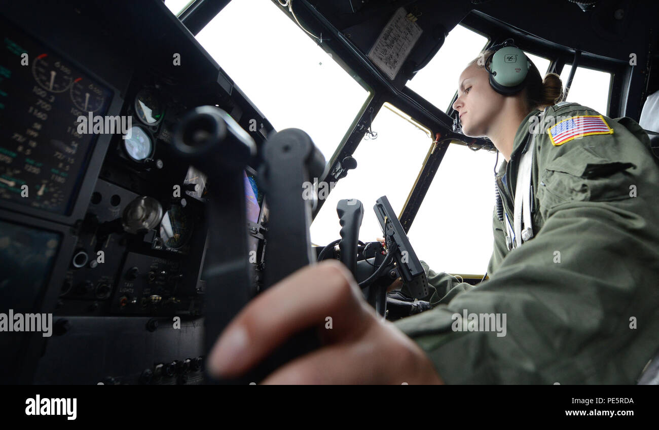 Lt. Allison Majcher pilots an HC-130 Hercules aircraft, the Coast Guard’s largest aerial asset, during a fisheries surveillance flight of the Pacific Northwest, Sept. 30, 2015. During the flight, the crew identified and documented 32 commercial fishing vessels in support of the Coast Guard's Living Marine Resources mission and partner agencies. (U.S. Coast Guard photo by Seaman Sarah Wilson) Stock Photo