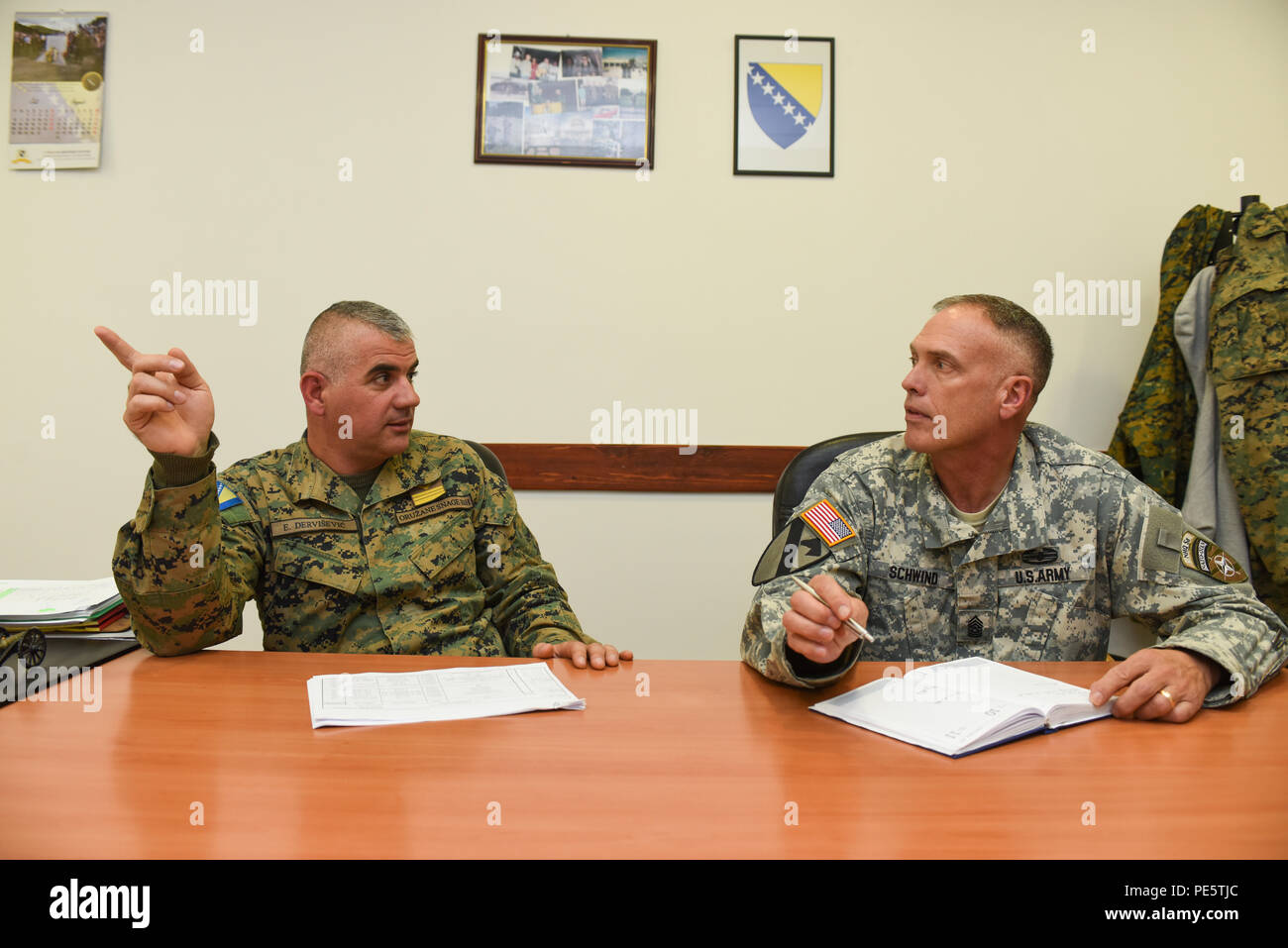Armed Forces Bosnia and Herzegovina Command Sgt. Maj. Emin Dervišević, Tactical Support Brigade, and U.S. Army Command Sgt. Maj. Harley Schwind, NATO Headquarters Sarajevo command senior enlisted leader, discuss future professional military education training opportunities Sept. 30, 2015, at Rajlovac Headquarters in Sarajevo, Bosnia and Herzegovina. Dervišević and Schwind are using this joint venture to impart leadership training in AFBIH junior enlisted leaders. U.S. Airmen, Soldiers and Marines from NATO Headquarters Sarajevo will be teaching the lessons during the course. (U.S. Air Force ph Stock Photo
