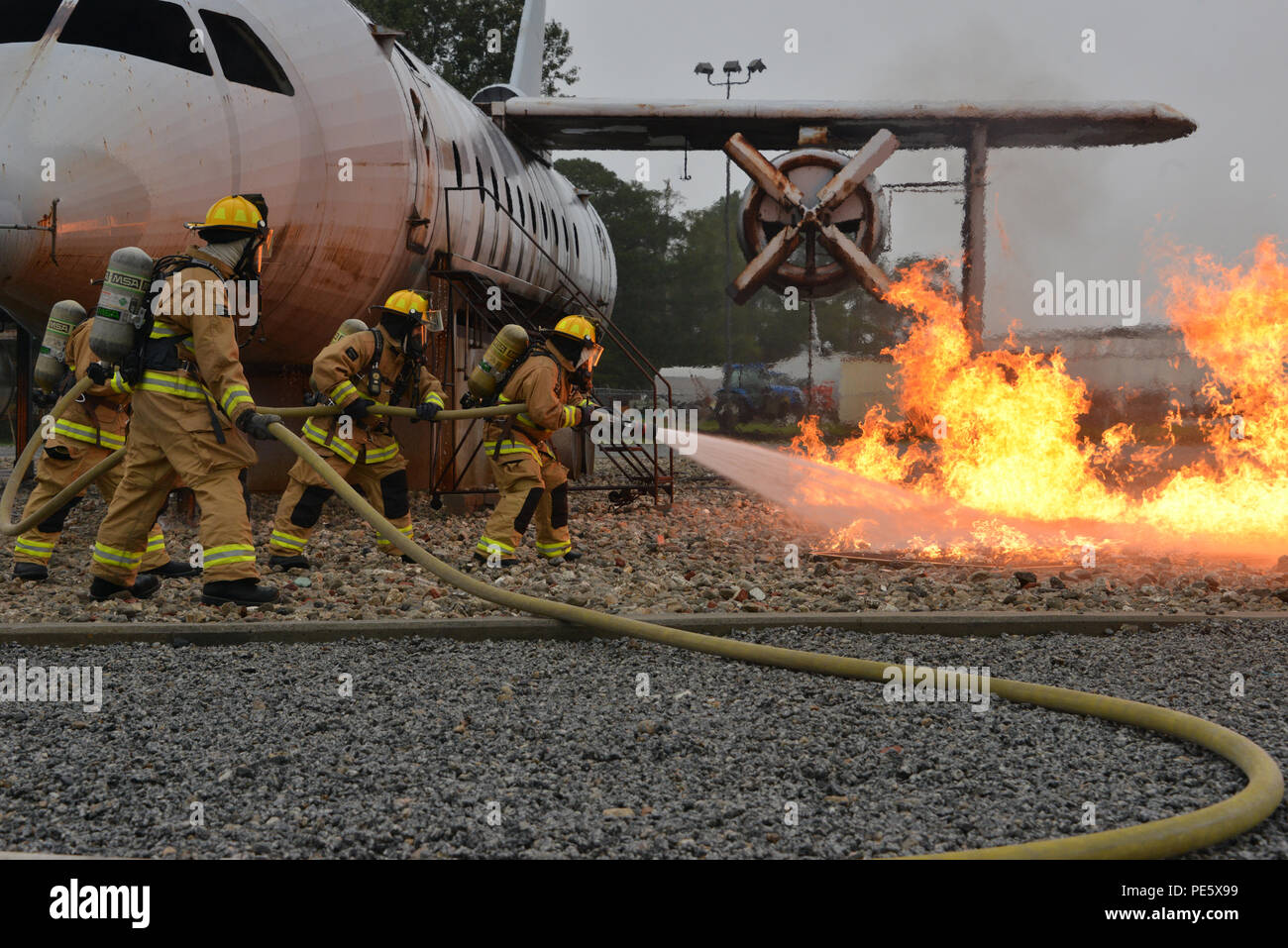 U.S. Air Force firefighters extinguish a controlled aircraft fire