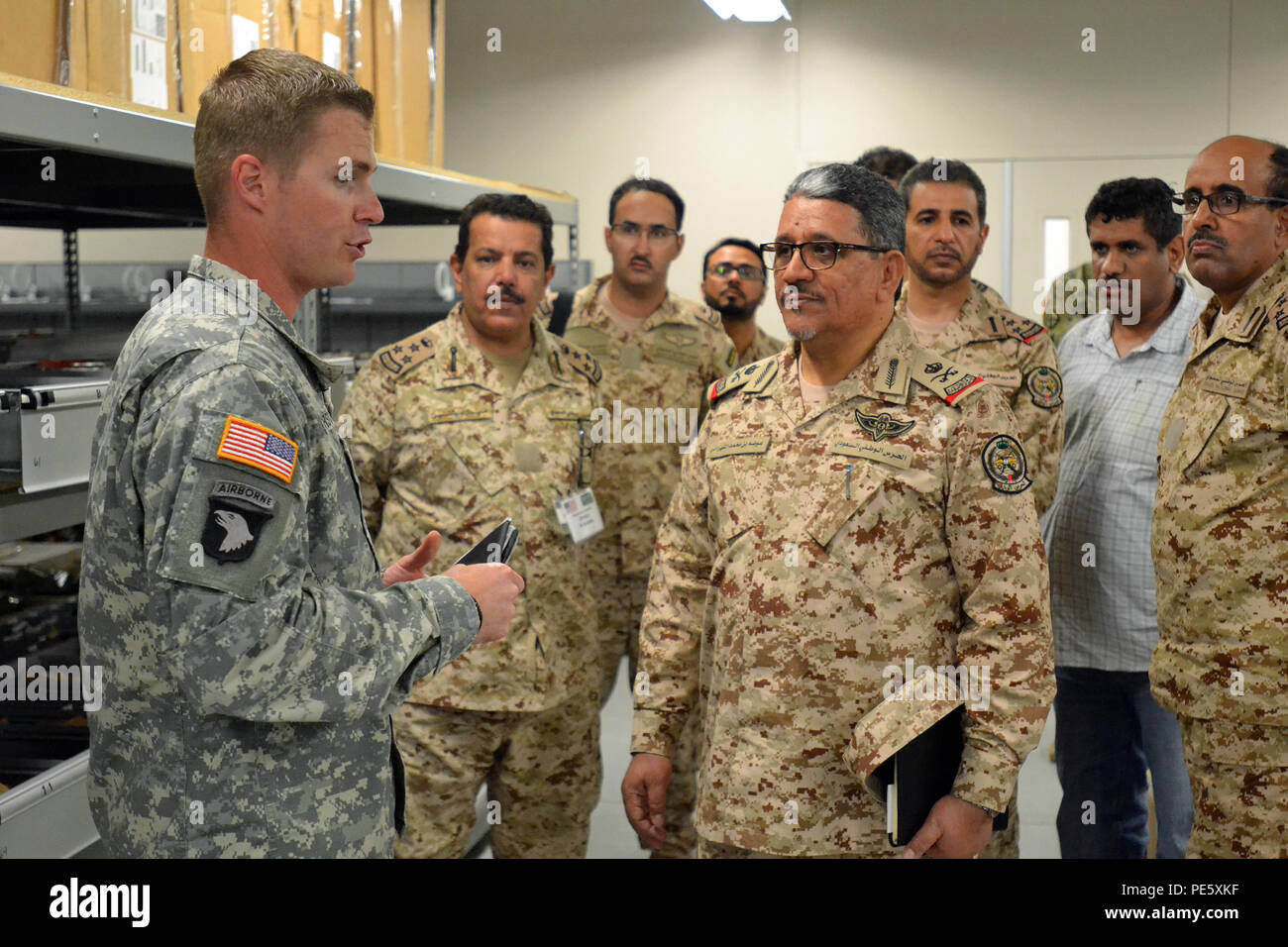 Chief Warrant Officer 2 David Marschall, left, shops aviation maintenance technician, Company B, 404th Aviation Support Battalion, 4th Combat Aviation Brigade, 4th Infantry Division, hosts Maj. Gen. Auda Mohammed Alshahrani, brigade commander of the Saudi Military, Saudi Arabian National Guard, and members of his staff for a tour of the various aviation maintenance and logistics officers during their visit to learn about brigade aviation maintenance and structure at Butts Army Airfield Sept. 23, 2015. (U.S. Army Photo by Sgt. Jonathan C. Thibault, 4th Combat Aviation Brigade Public Affairs Off Stock Photo